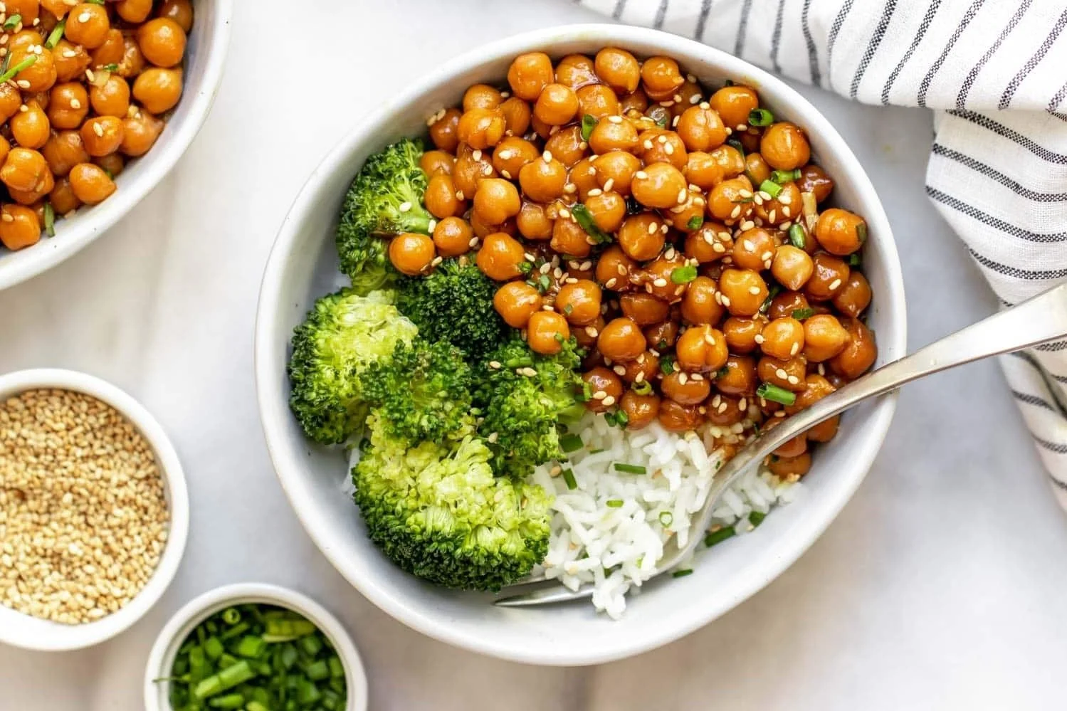 bowl of sticky sesame chickpeas with rice and broccoli