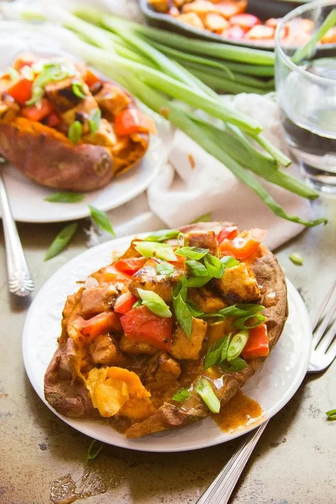 GINGER TEMPEH STUFFED SWEET POTATOES WITH ALMOND BUTTER SAUCE