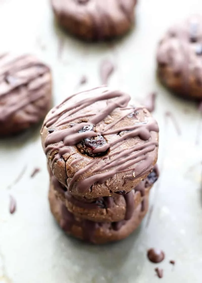 Stacked chocolate cookies with chocolate drizzle on top.