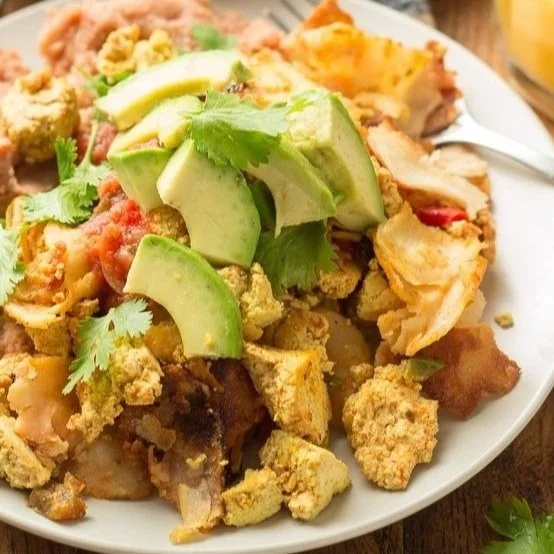 plate of tofu migas topped with avocado