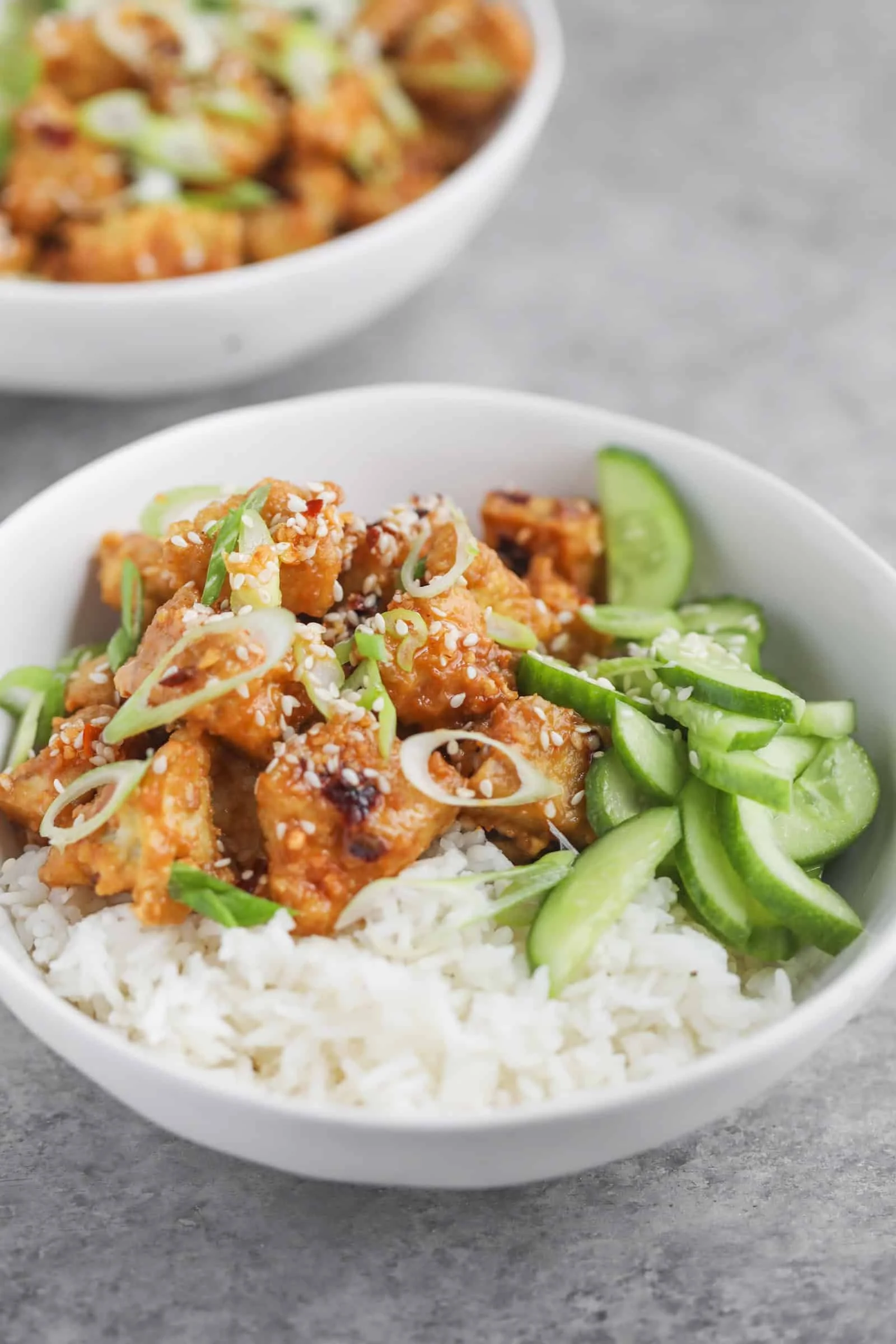 CHILI CRISP TOFU BOWLS WITH CUCUMBER SALAD AND RICE