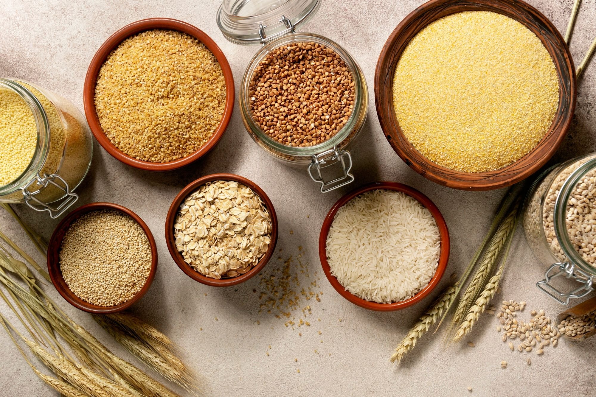 grains in bowls including oats, rice, couscous, barley