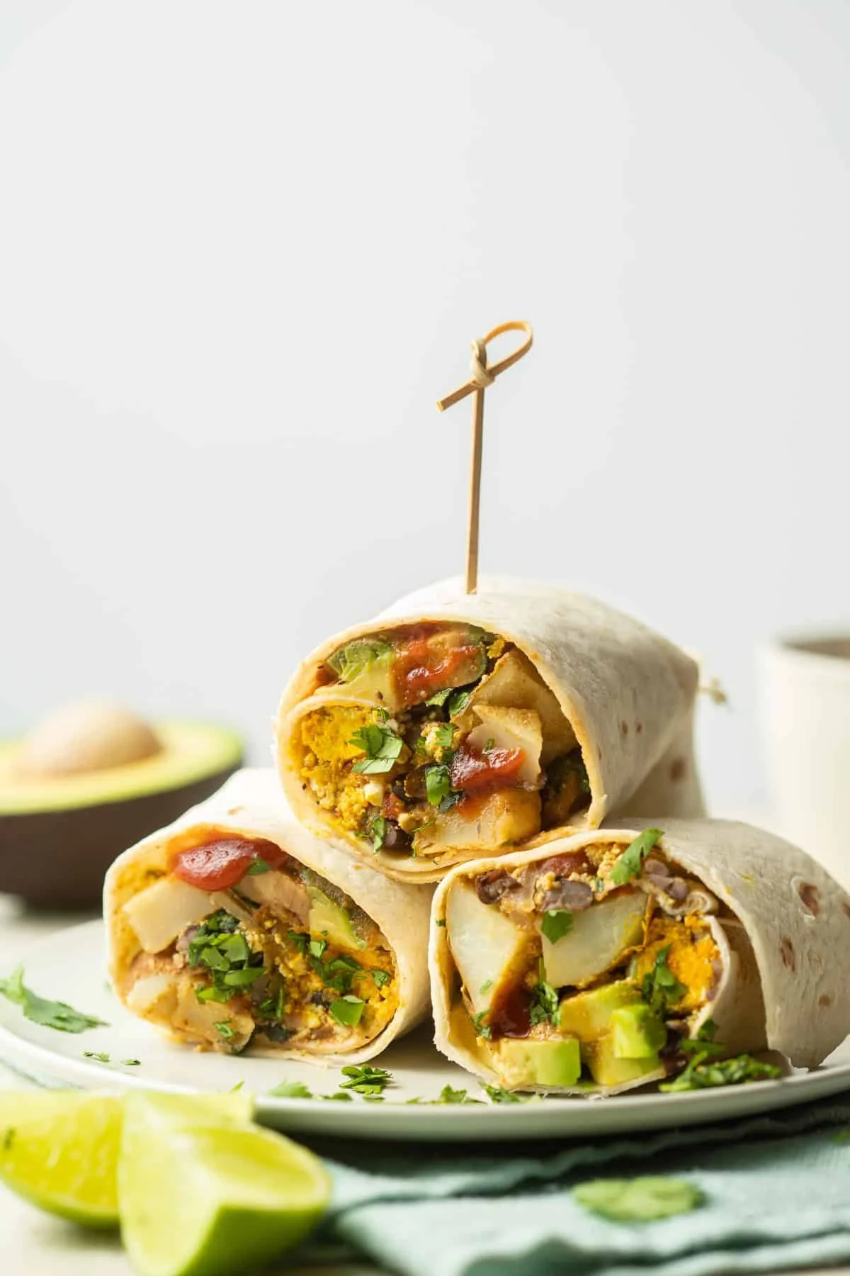 cross section of 3 vegan breakfast burritos