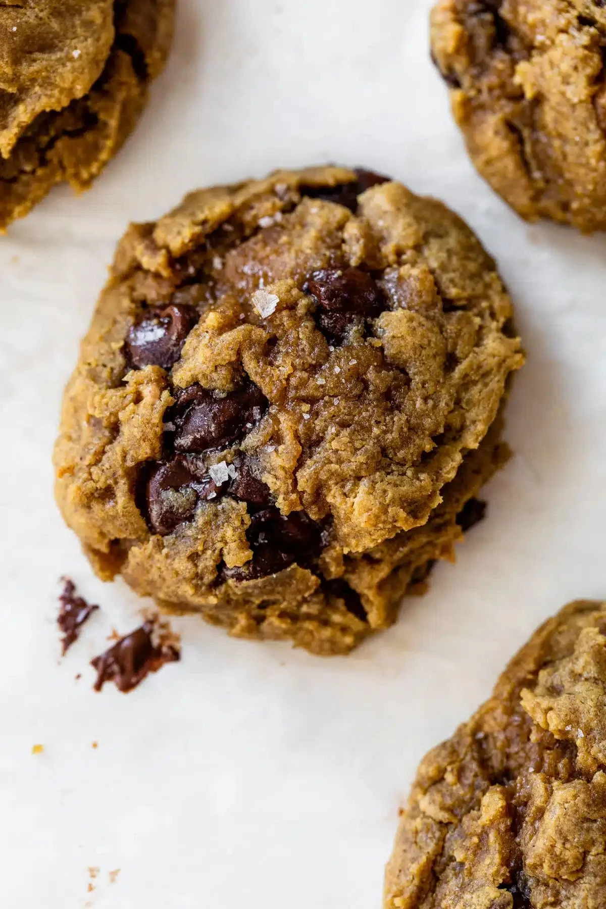 Vegan Chocolate chip cookies on a white surface.