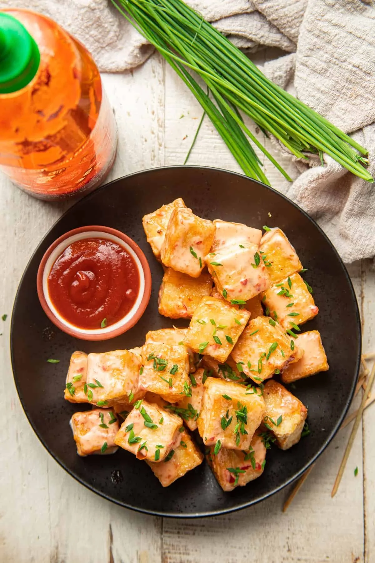 plate of bang bang tofu with side of sriracha