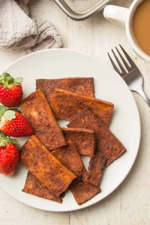 tofu bacon on plate garnished with fresh strawberries