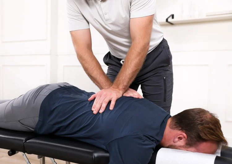 Dr. Yossi Stein performing a prone thoracic adjustment at Stein Chiropractic in Clairemont, San Diego