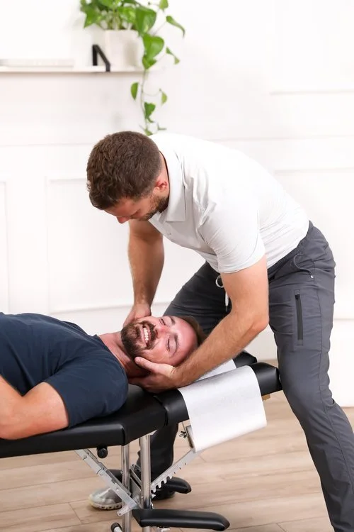 Dr. Yossi Stein performing a supine neck adjustment at Stein Chiropractic in Clairemont, San Diego