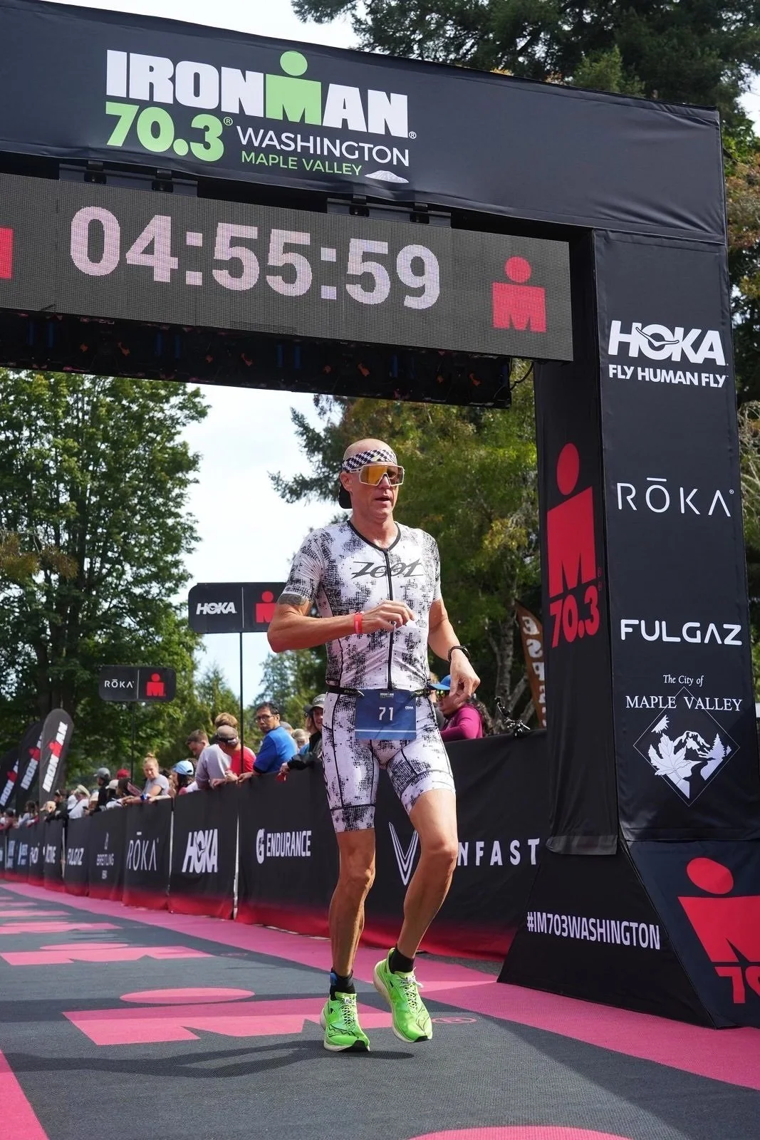 Stein Chiropractic triathlete patient finishing a 70.3 race after training support in San Diego