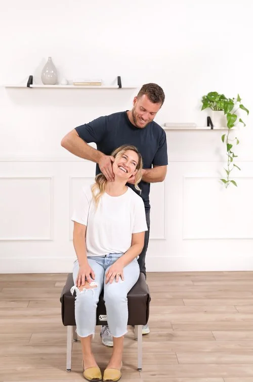 Dr. Yossi Stein setting up for a Gonstead seated cervical adjustment at Stein Chiropractic in San Diego