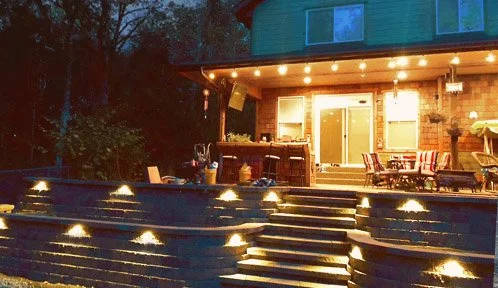 Multi-tiered retaining wall with staircase and integrated lighting