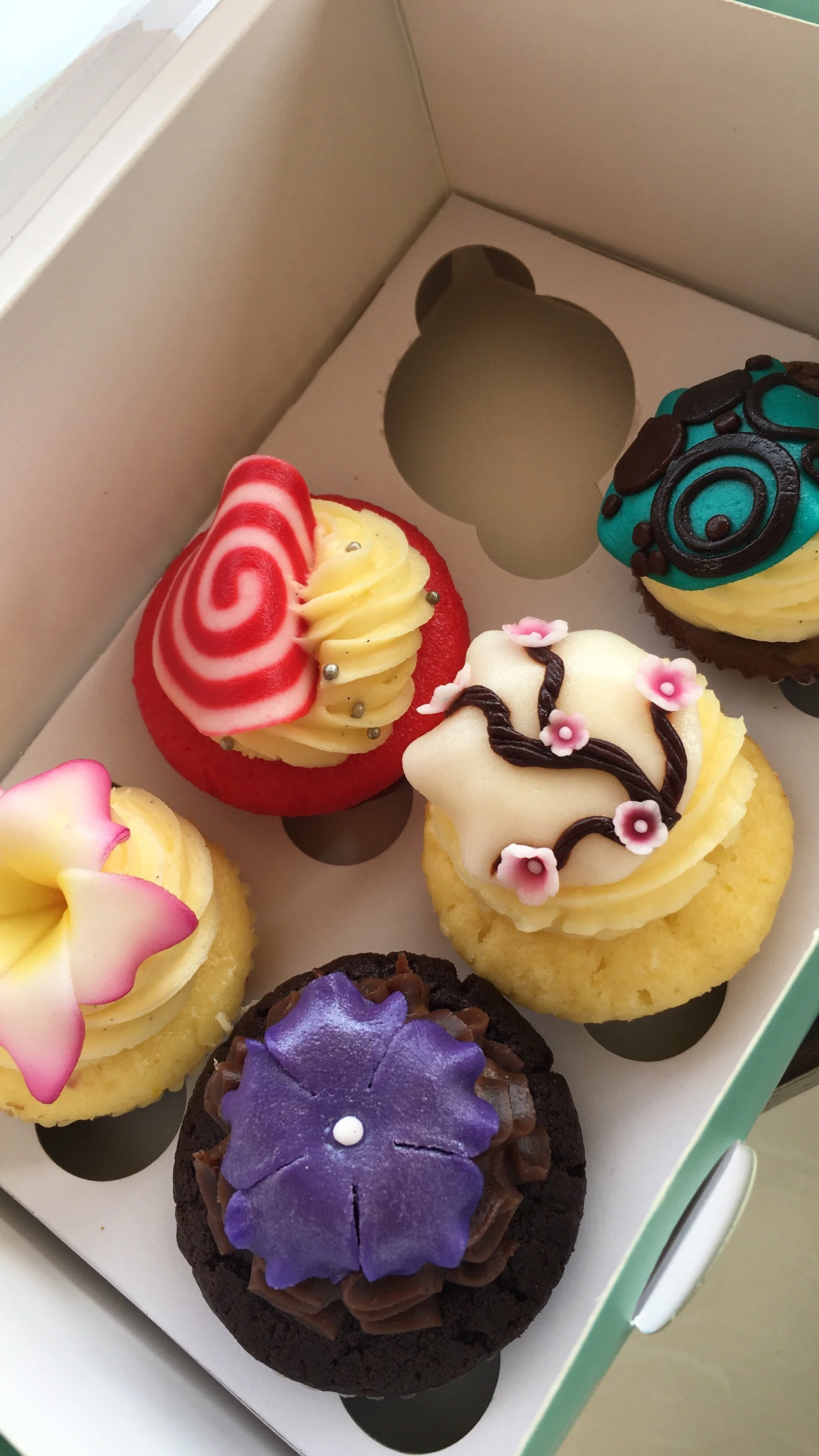 colorful cupcakes in a paper box