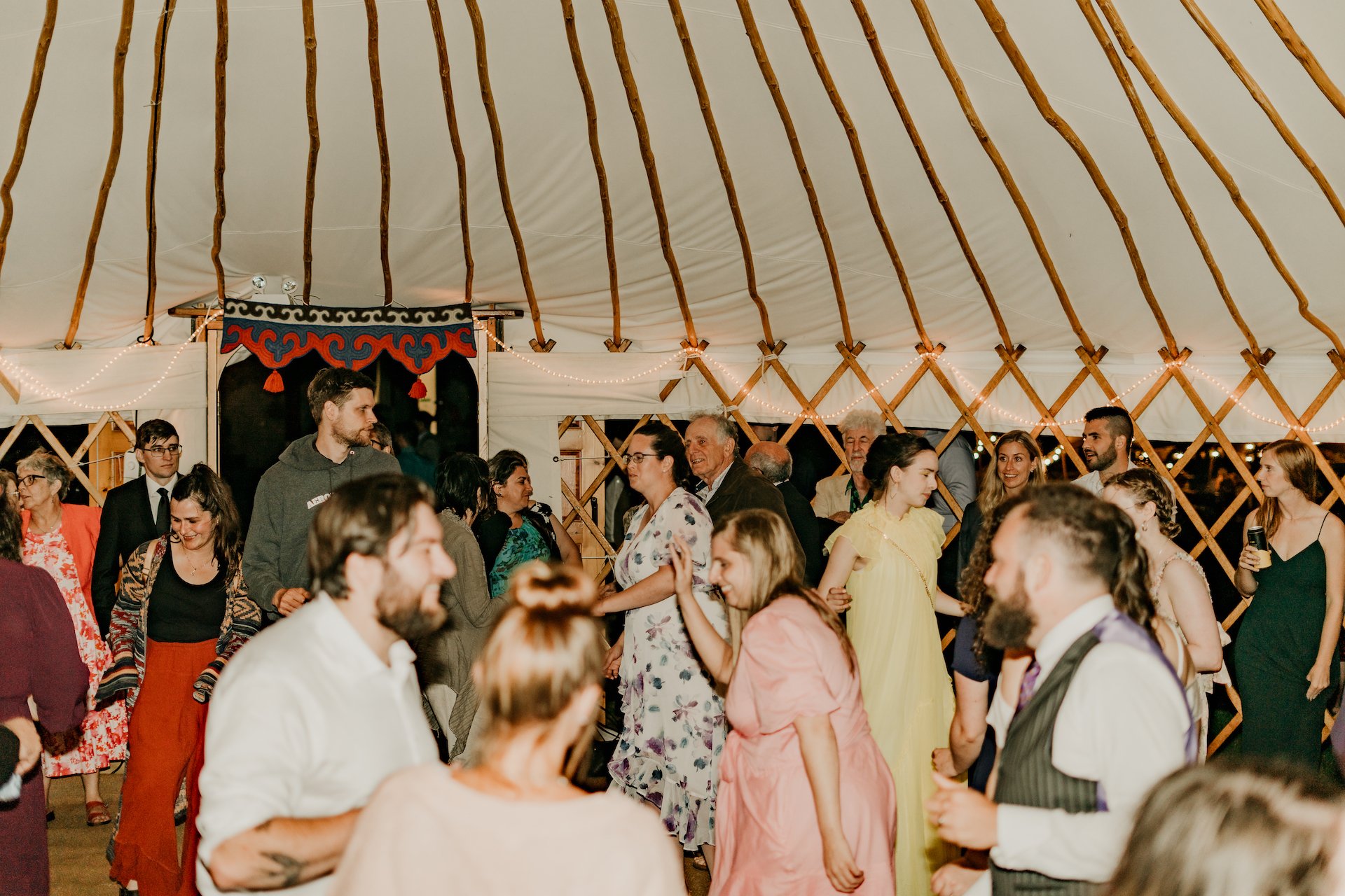 Guests dancing in the palace yurt with the door decoration.