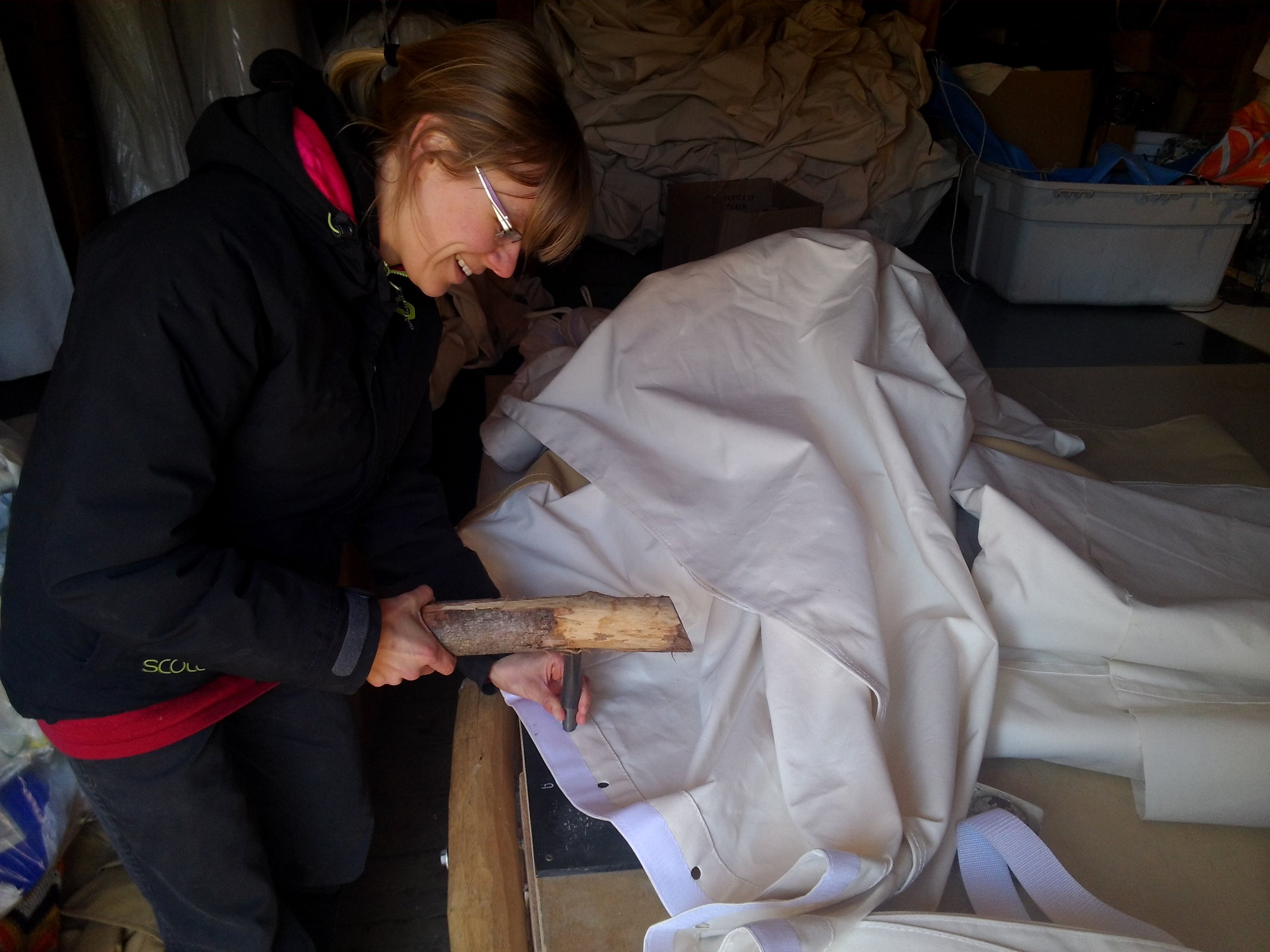 Setting brass spur grommets into a roof cover.