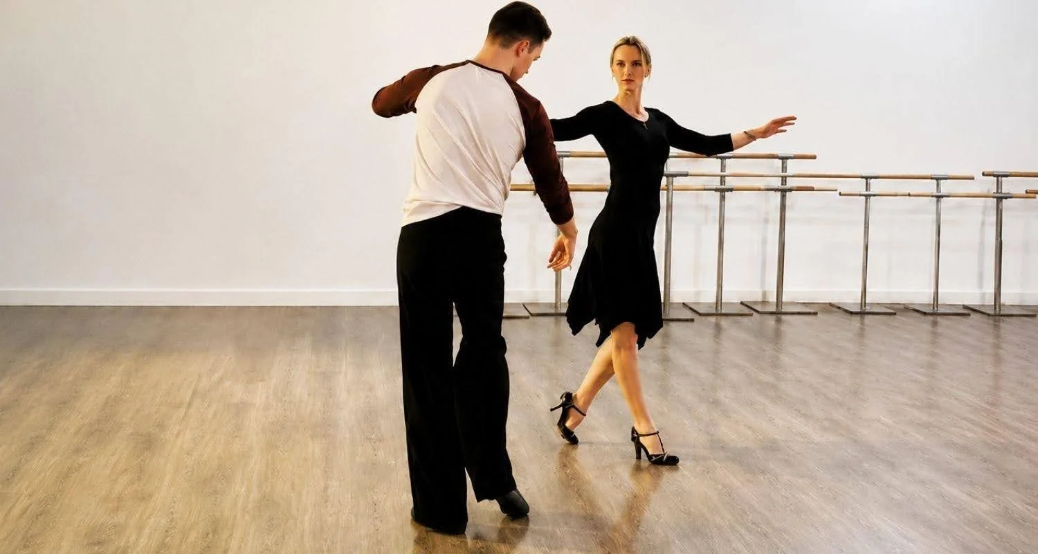 Instructor guiding a student through Tango steps during a private dance lesson in Marbella