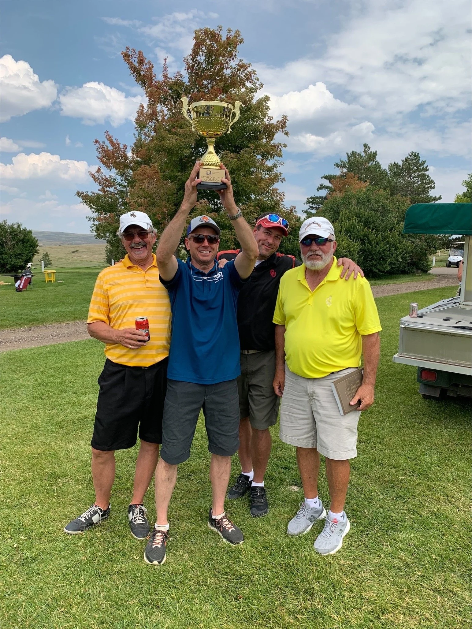 Cathedral Cup winning team together holding the trophy into the air