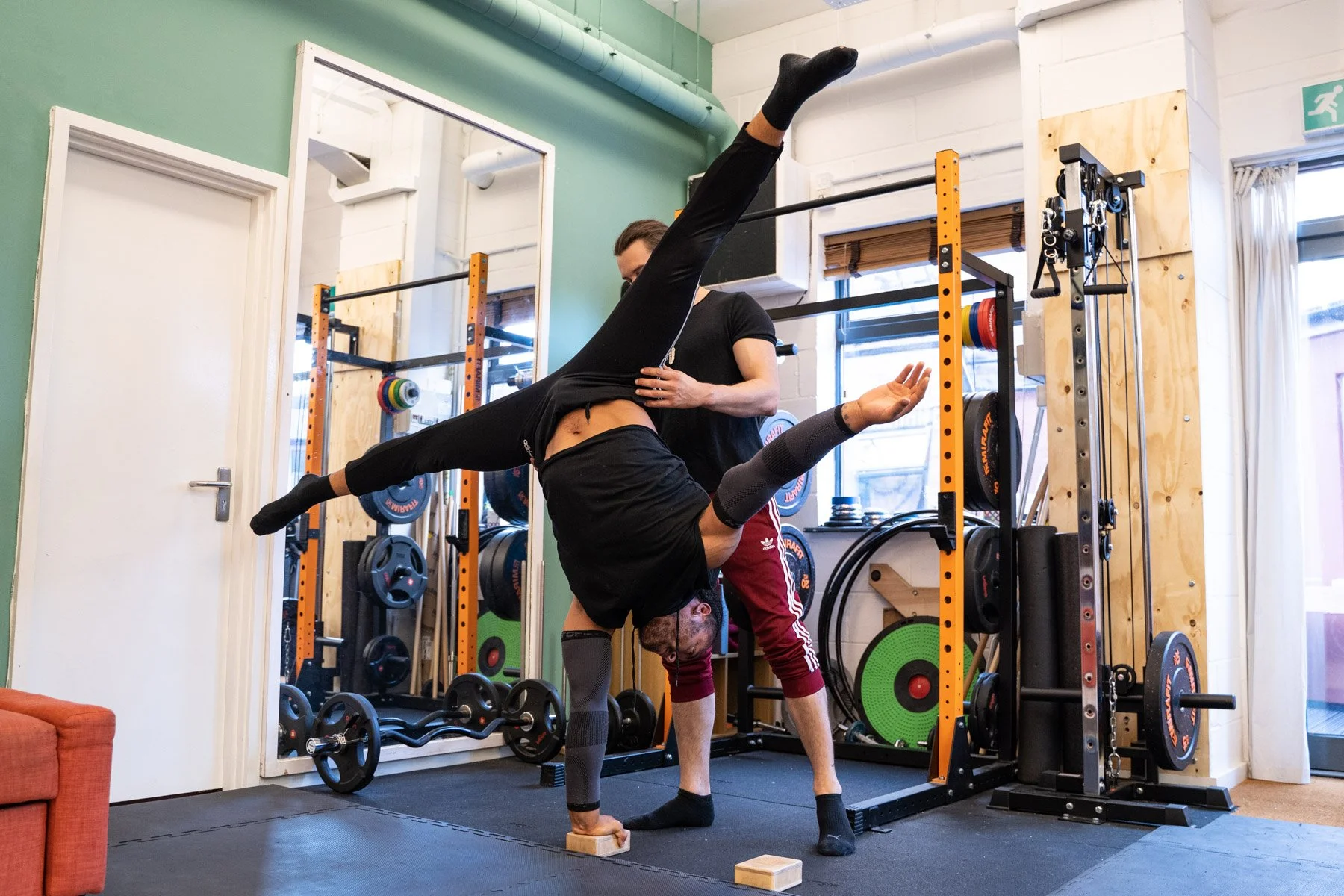 Handbalancer training with a specialist handstand coach at Secret Studio, a private circus and aerial training studio.