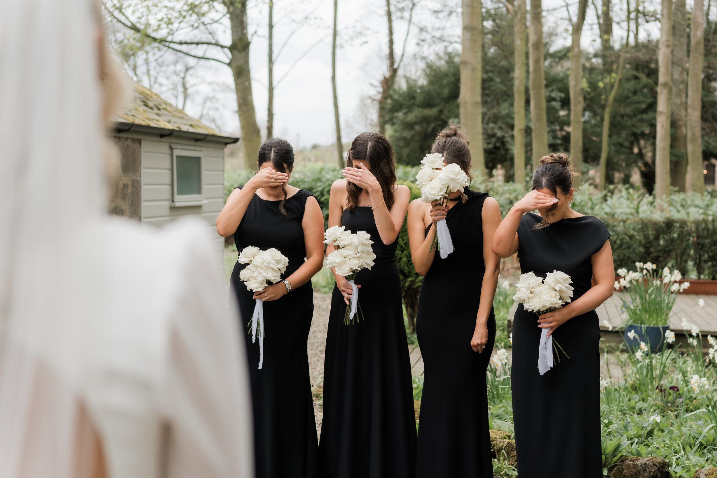 Emotional first look with the bride and bridesmaids in black-tie attire at Charlton Hall