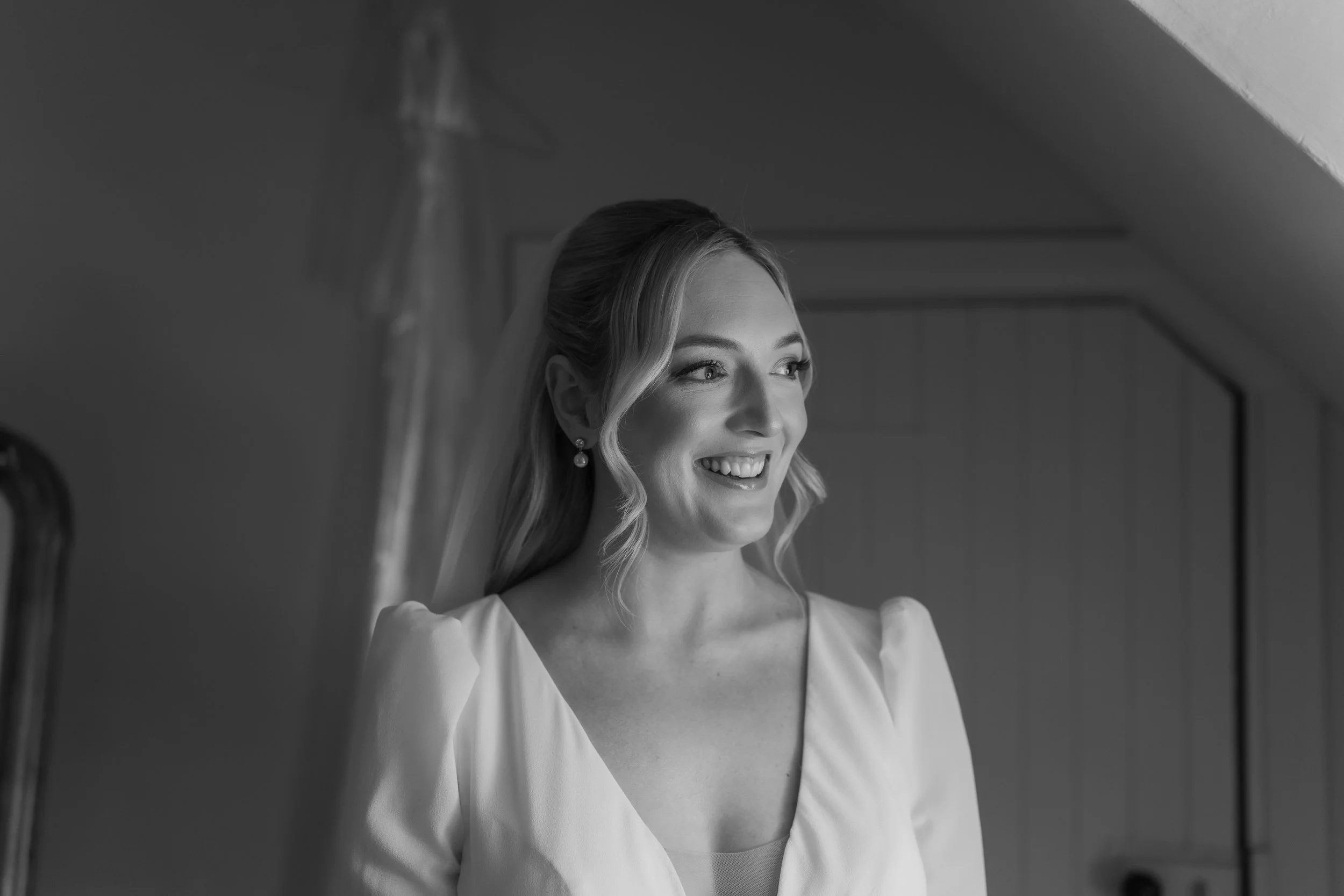 Candid bridal portrait in natural light at Charlton Hall, captured in a quiet moment before the ceremony