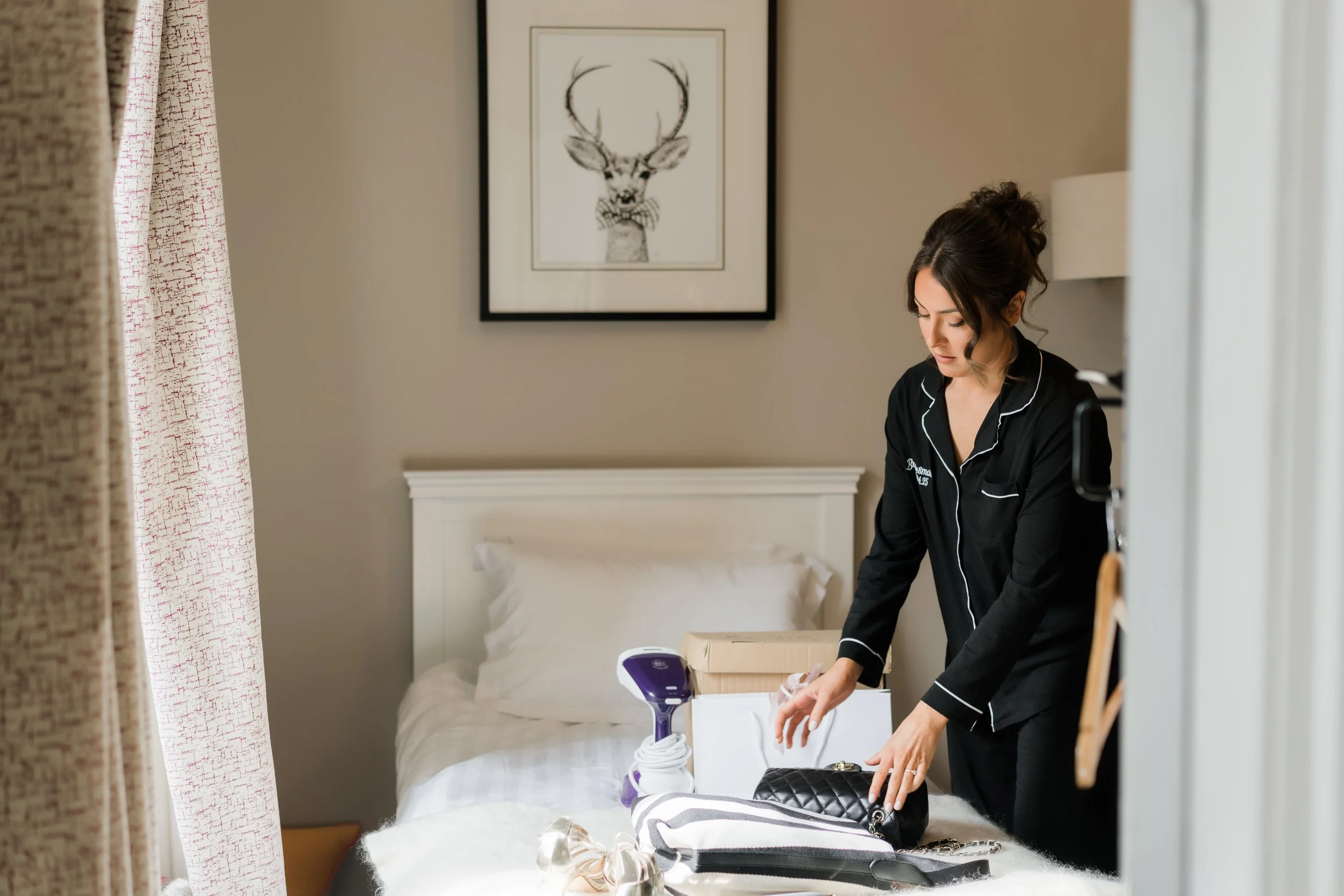 Bride and bridesmaids getting ready together on the wedding morning at Charlton Hall, captured in soft natural light