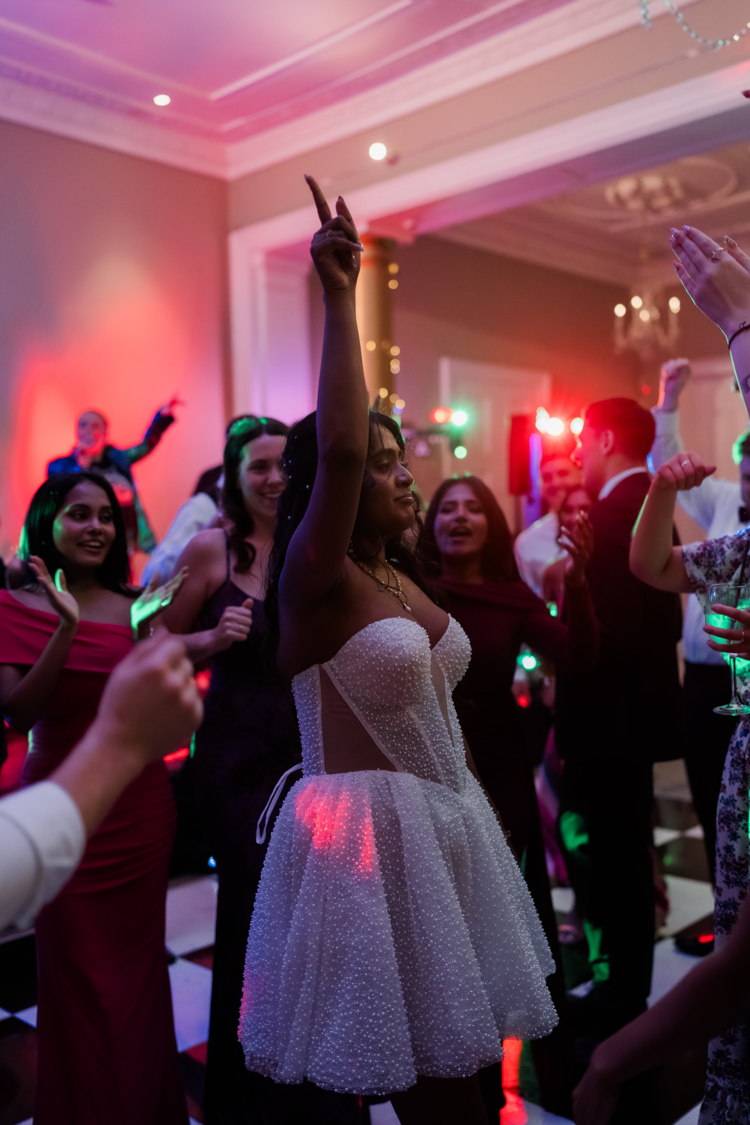 Bride dancing lit by neon DJ lighting no flash Rudding Park