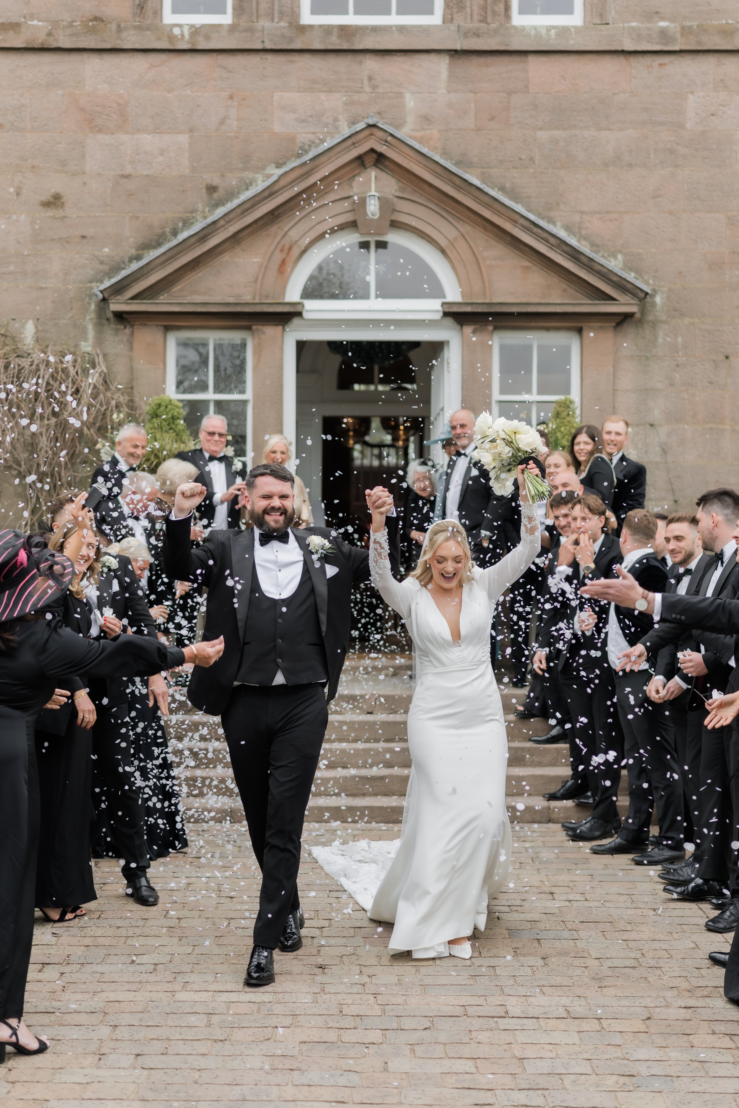 Unposed confetti moment with real reactions and joy, captured in a documentary wedding style