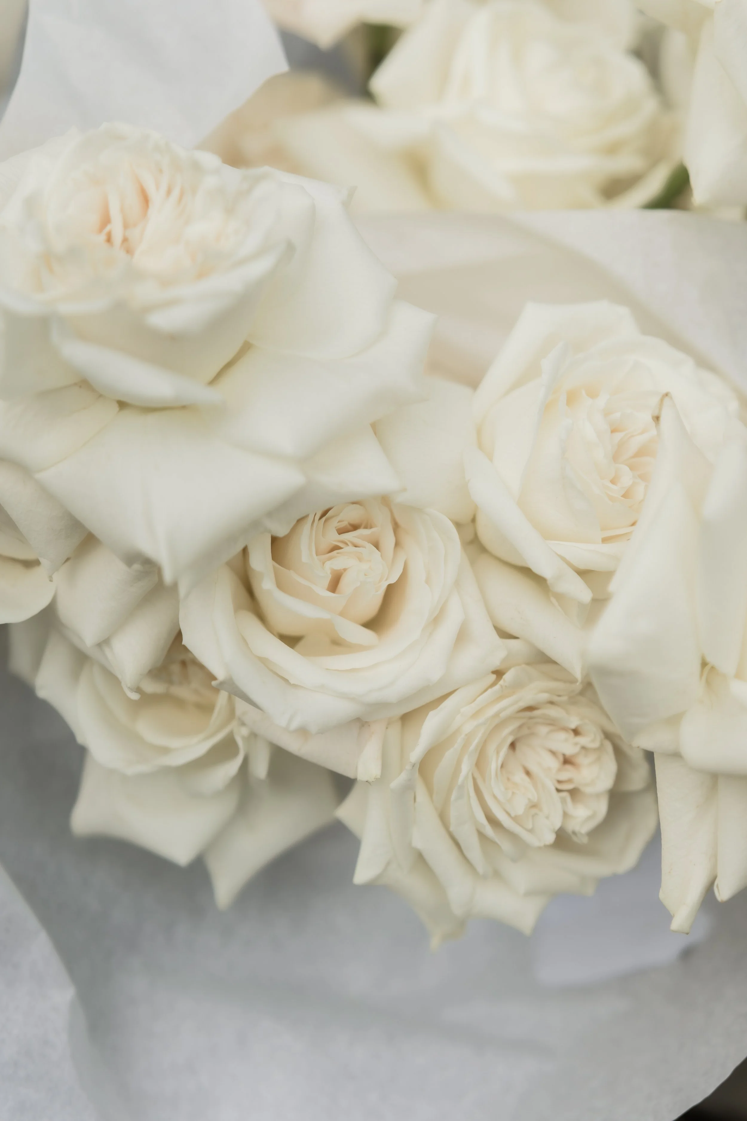 Close-up of wedding flowers styled with seasonal blooms and a fine art feel