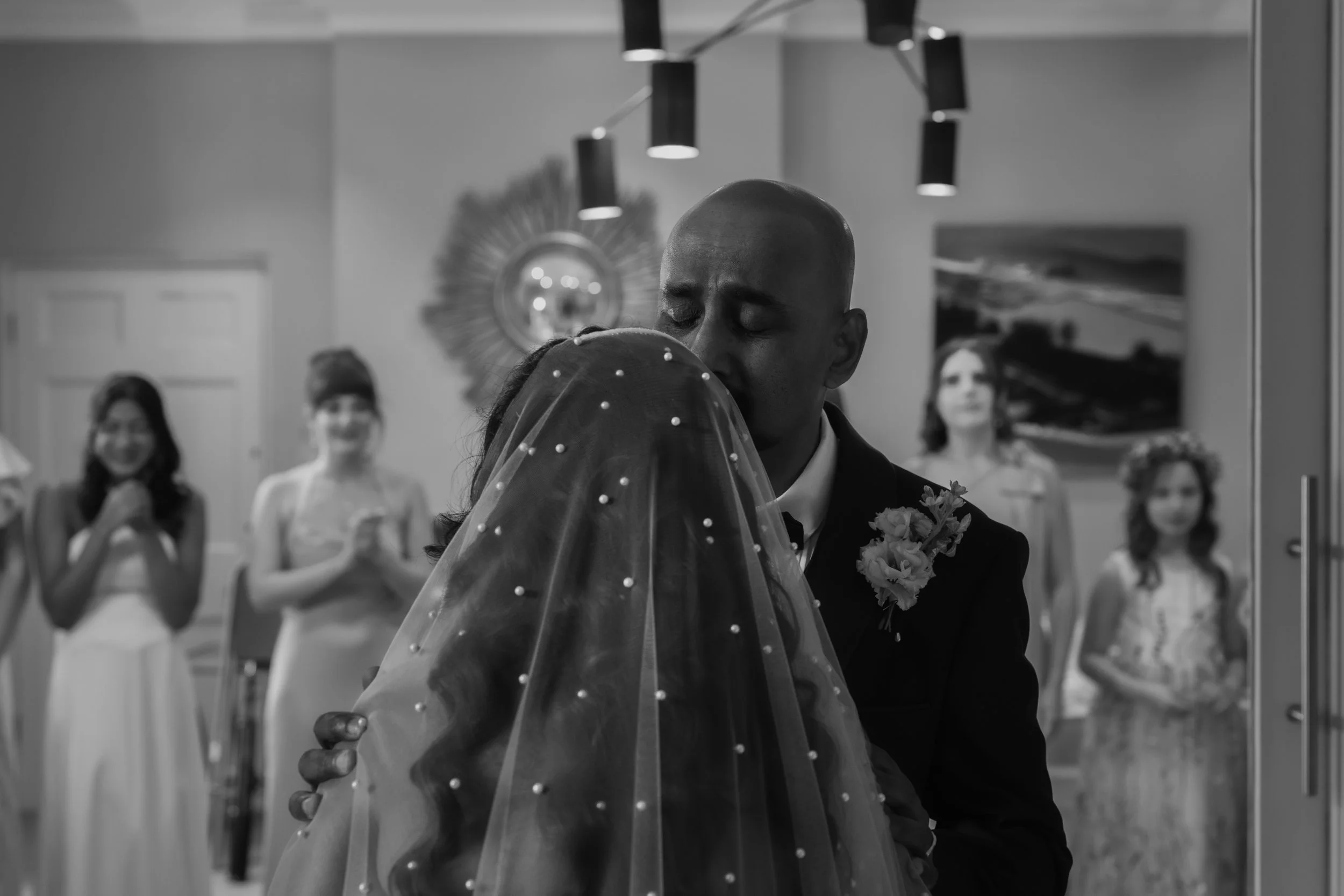 Emotional first look with father of the bride. Father of the bride kiss brides forehead. Black and white