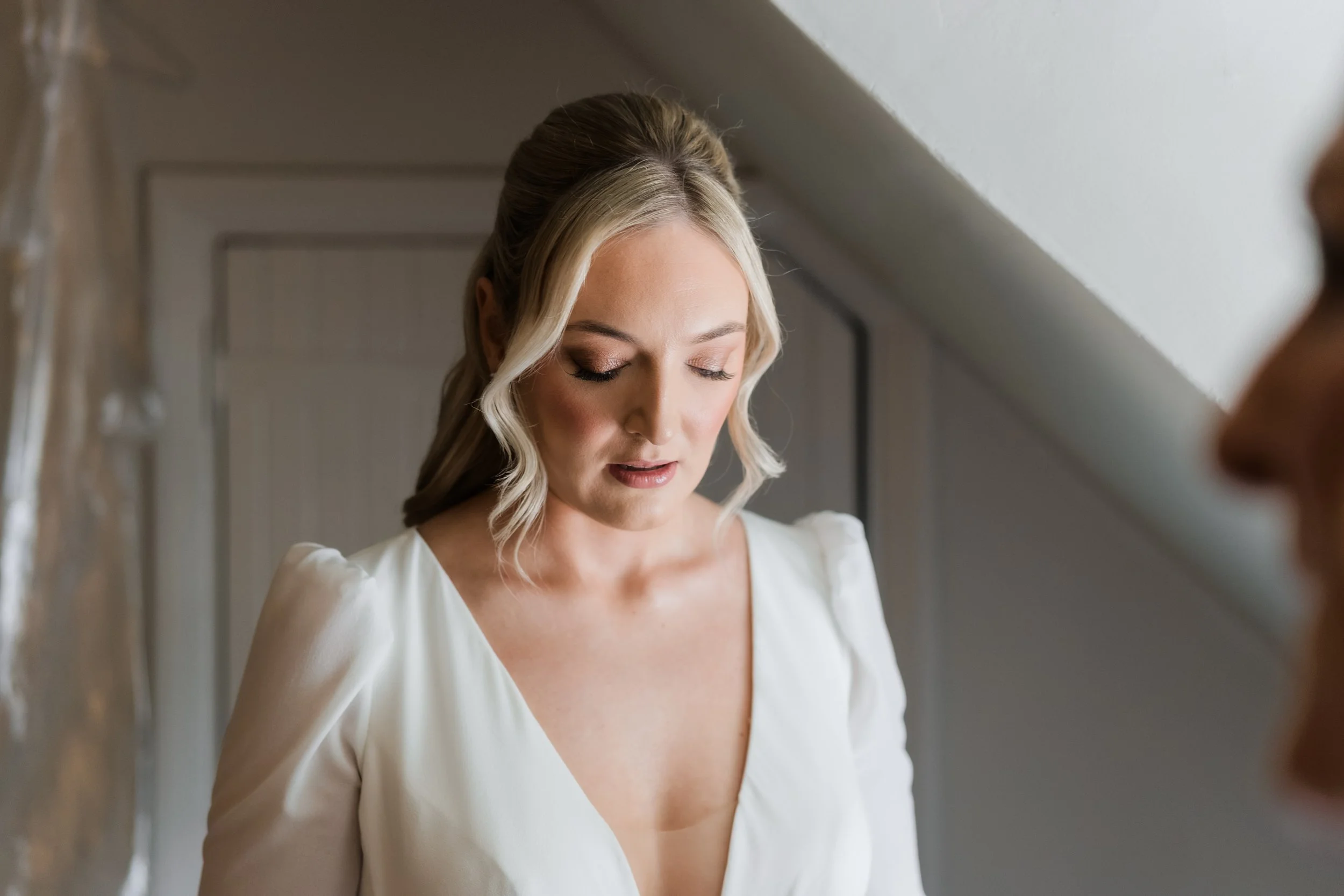 Candid bridal portrait in natural light at Charlton Hall, captured in a quiet moment before the ceremony