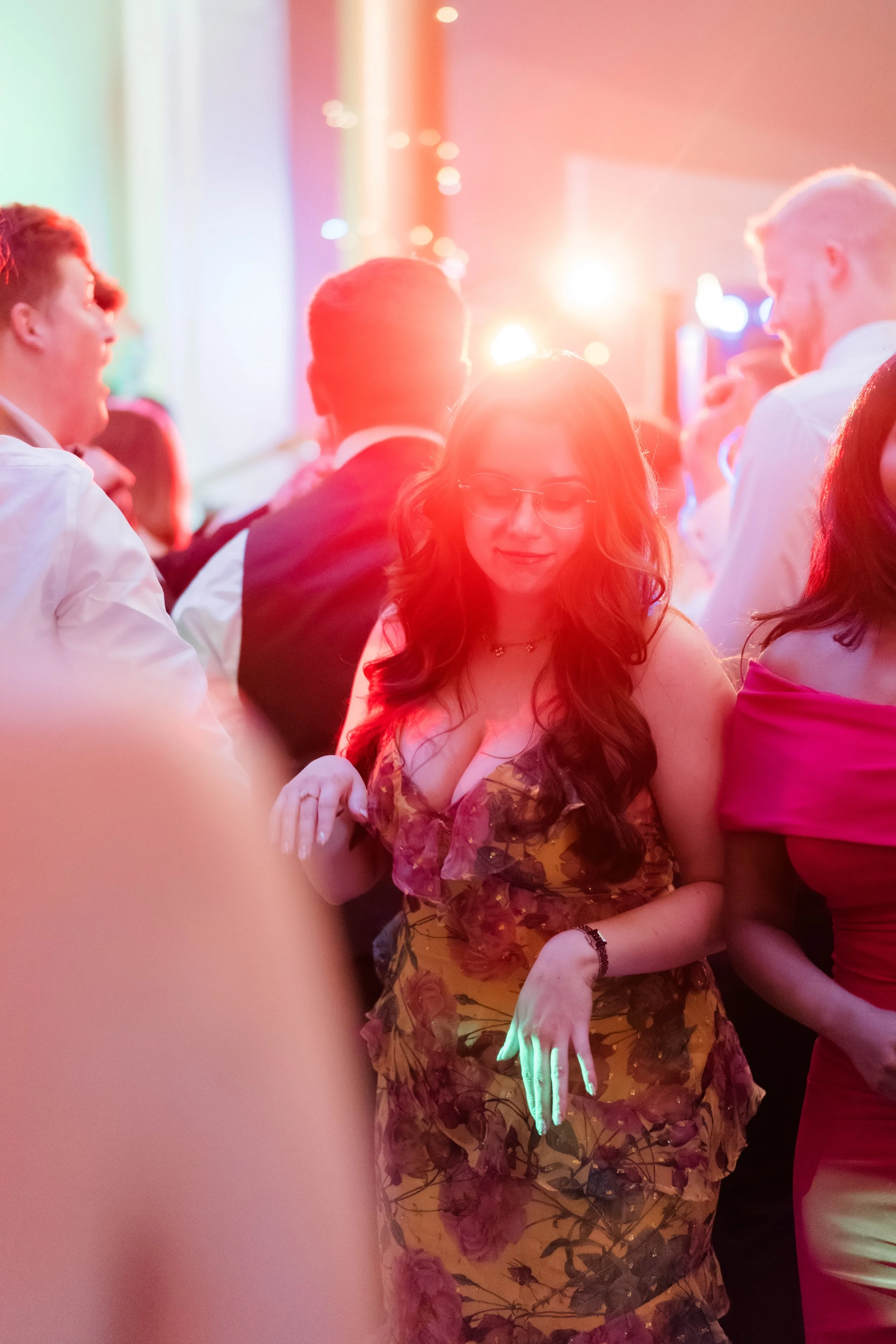 Wedding guest dancing lit by neon DJ lighting no flash Rudding Park