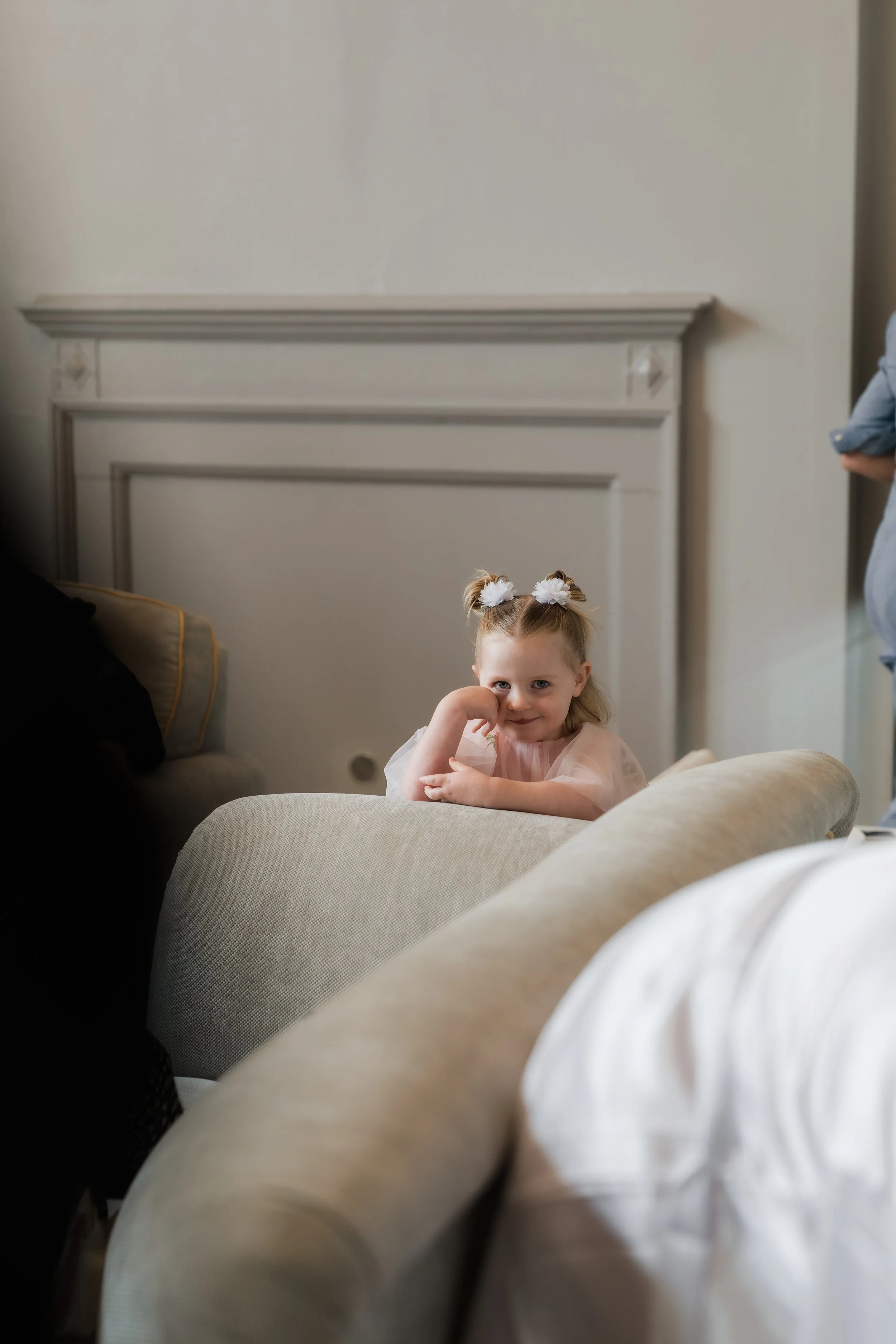 L&J Wedding Photography & Videography. Documentary Yorkshire Weddings.  Flower girl leans on arm of char