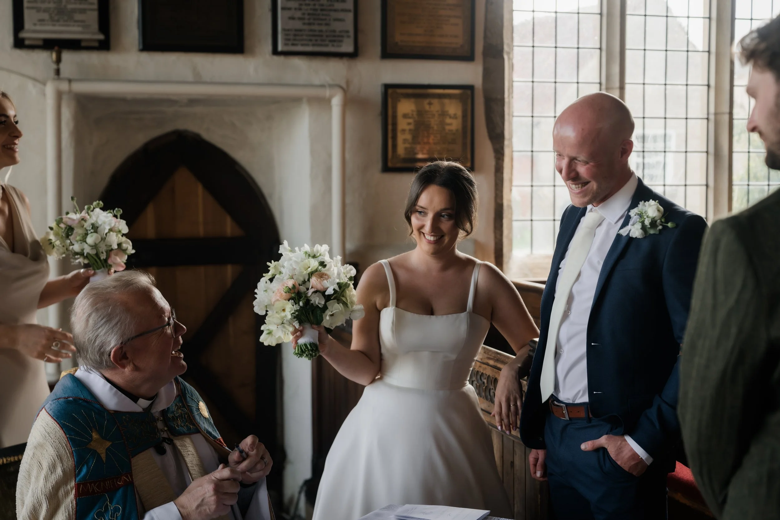 Micro wedding bride smiles with groom and vicar, North Yorkshire