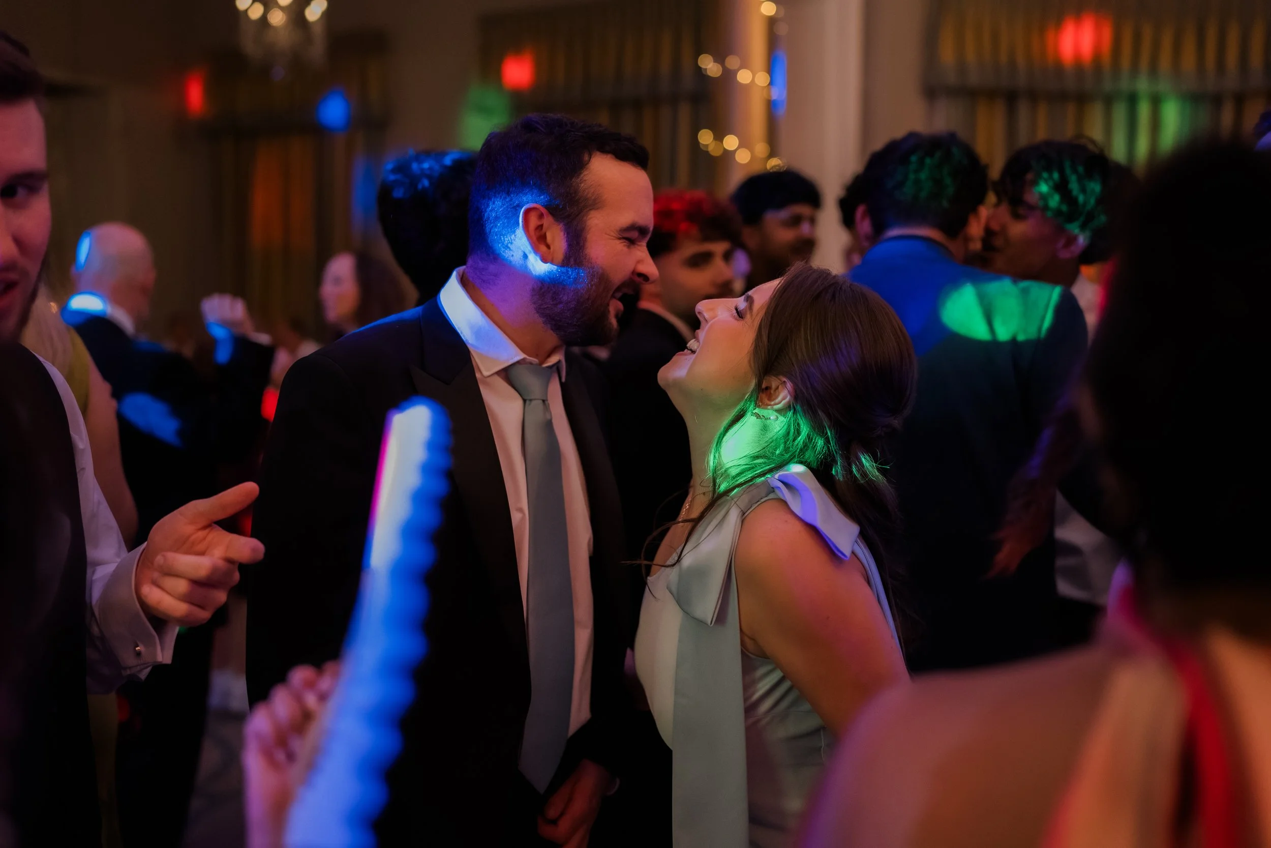 Wedding guests dancing lit by DJ lighting no flash Rudding Park