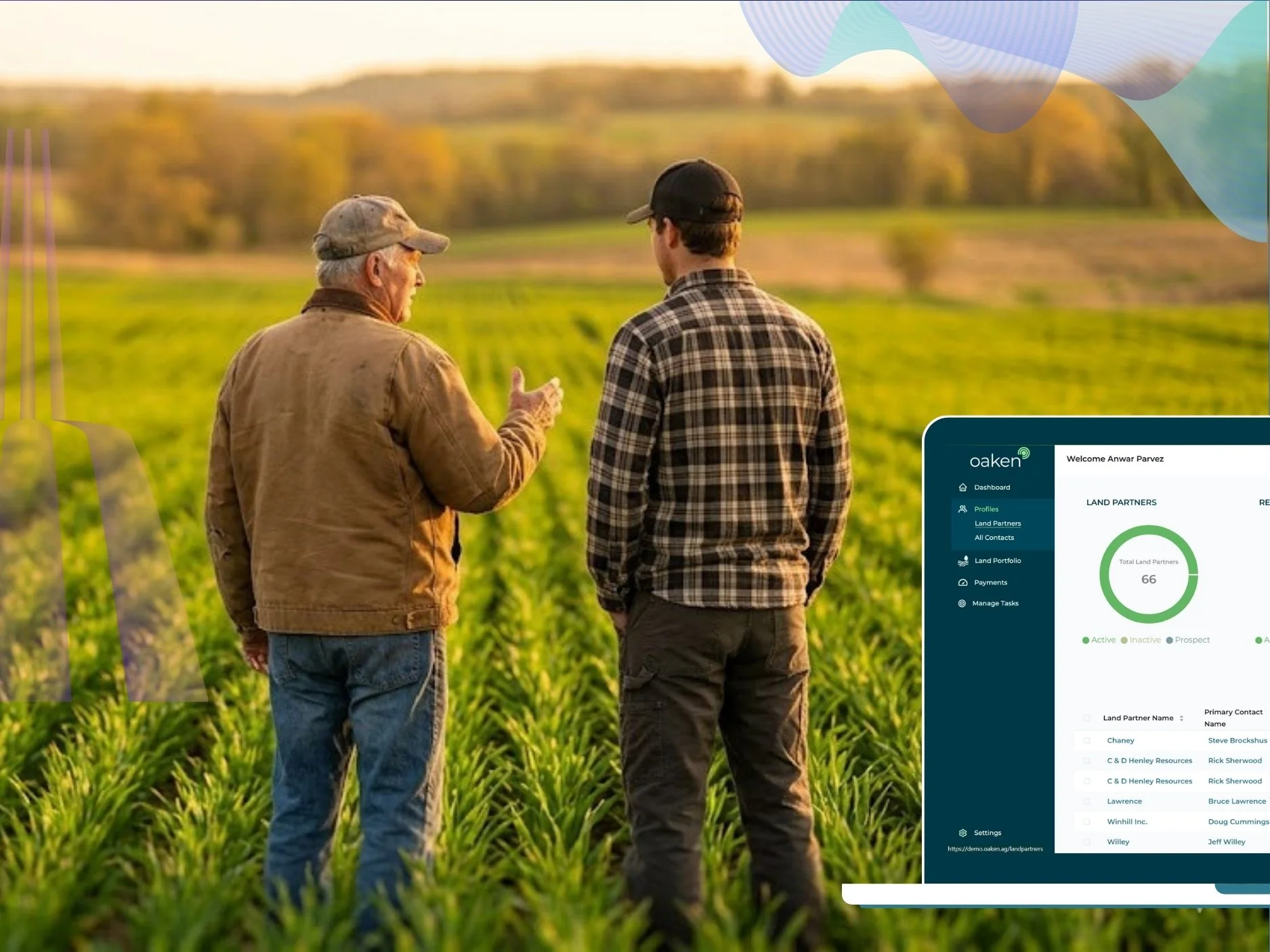 Two men in a field of green crops, one older and one younger, having a conversation during sunset with a landscape of rolling hills and trees in the background.