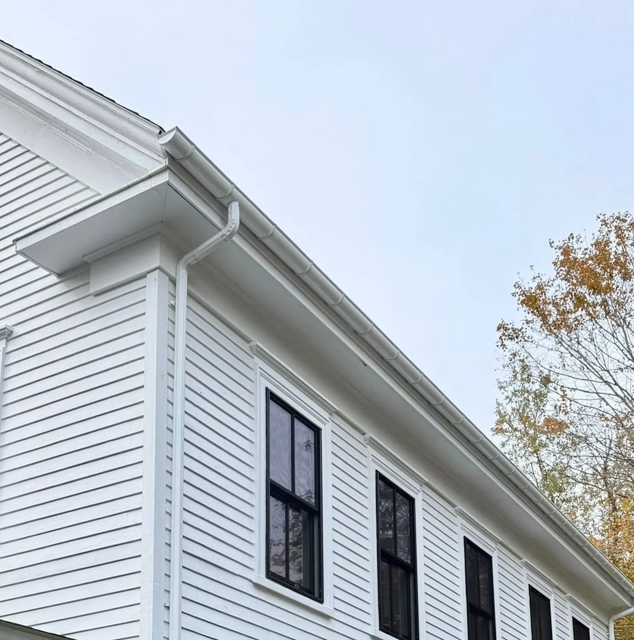Crisp, classic, and built for New England weather ❄️🍁

White gutters on a white house create a timeless look while handling everything from heavy snowmelt to spring rain. 

Durable, low-maintenance, and designed to blend seamlessly with your home&rs