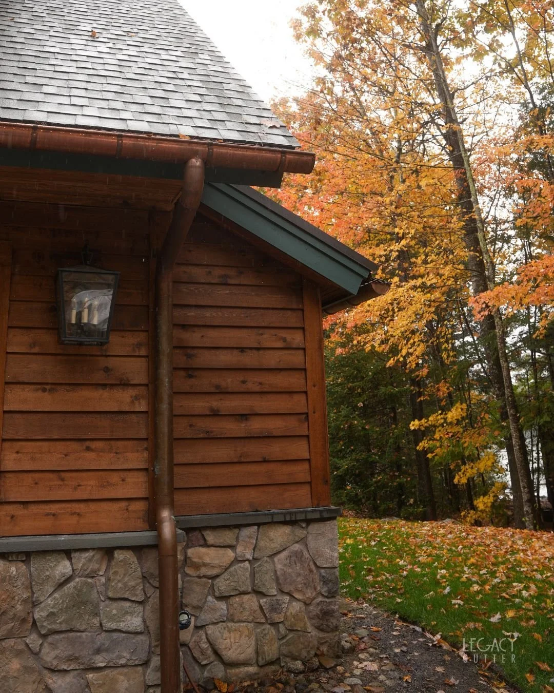 Cedar shingles, fieldstone and copper half-round gutters. 🍁

Copper starts bright and weathers to a deep brown, then a soft green over the years, so it looks more at home on a house like this every season.

Every copper system we build is shaped and