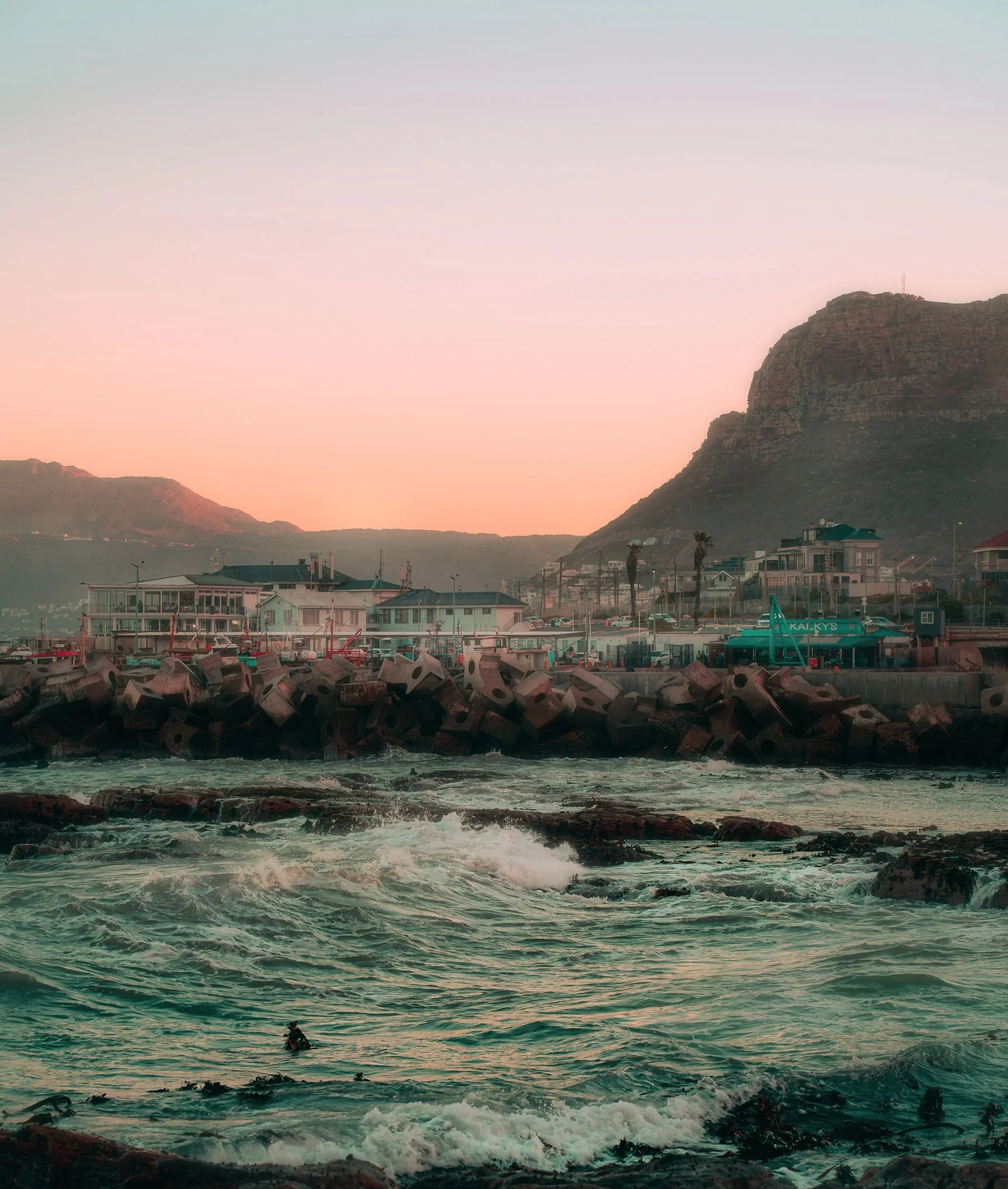 TRAVEL+Kalk+Bay+Surfer+by+Pier+SOUTH+AFRICA+2025.jpg