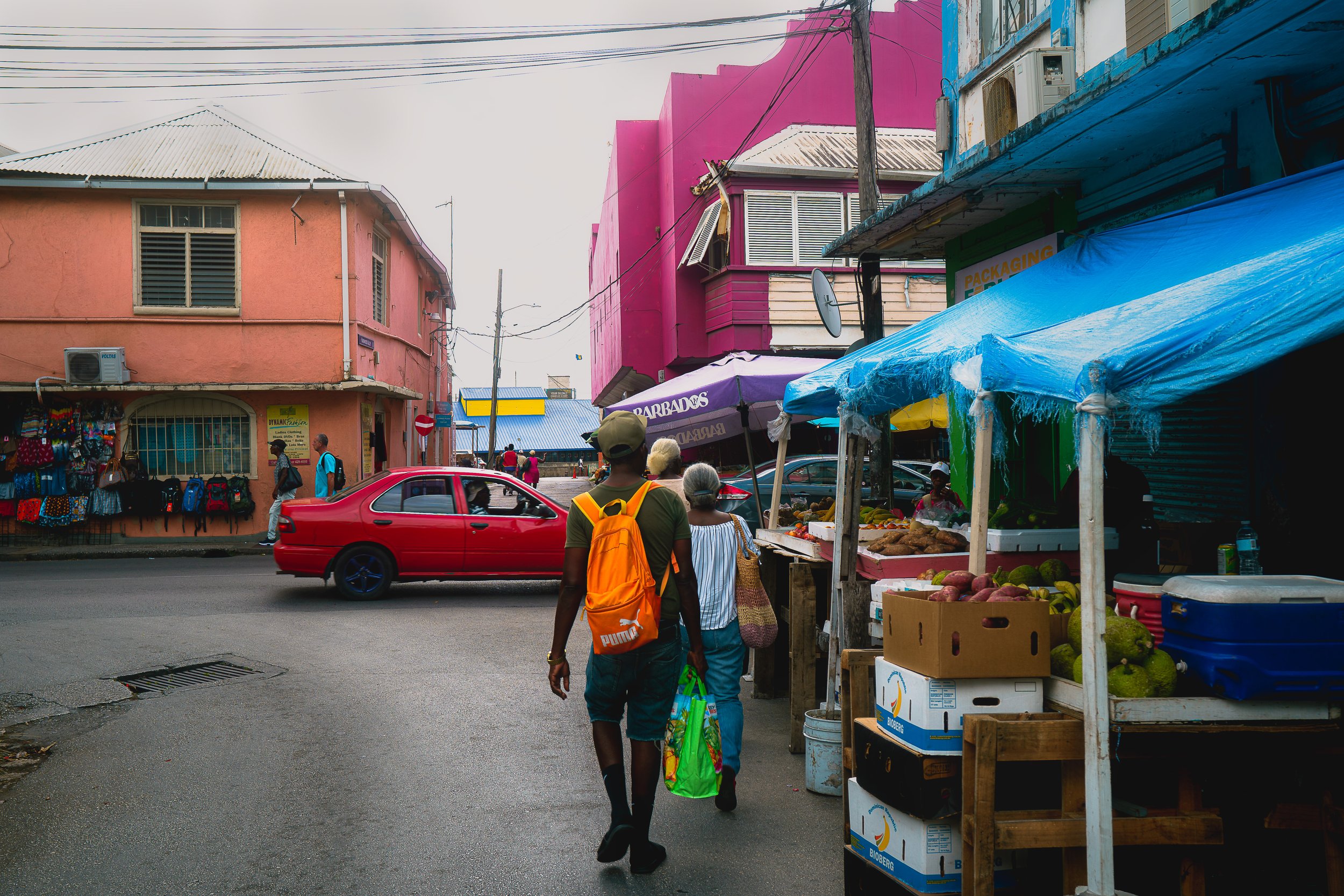 TRAVEL Bridgetown Man w Orange Backpack BARBADOS 2026.jpg