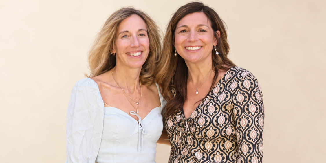 Physician sisters Dr. MaryBeth Parisi and Dr. Susan Parisi smiling together.