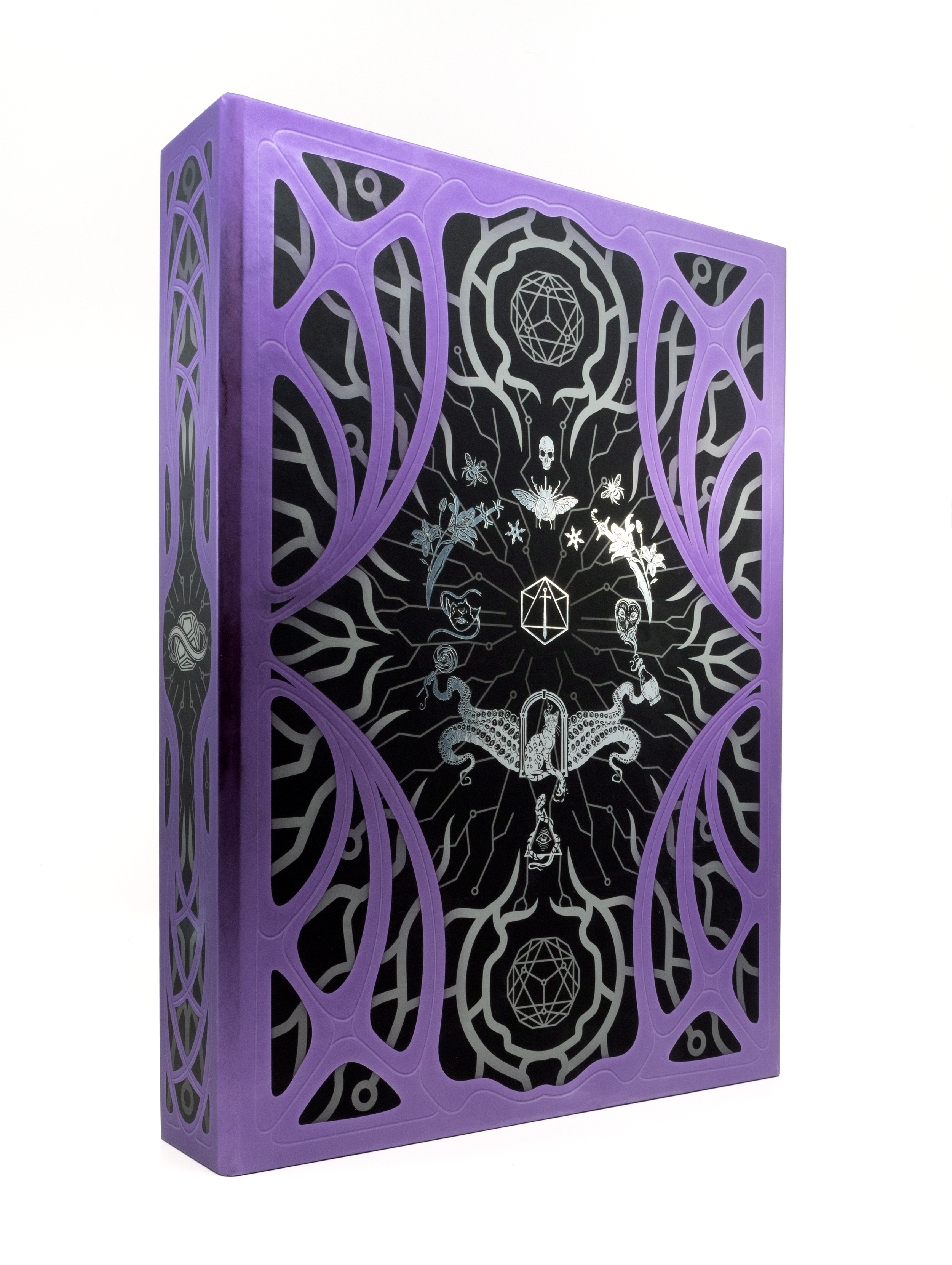 This book clamshell is purple with a black background & silver detail. The artwork shows the Critical Role logo in the surrounded by iconography (including a cat in a doorway, tentacles, a lollipop, a mask, an owl, swords, insects, flowers & a skull)