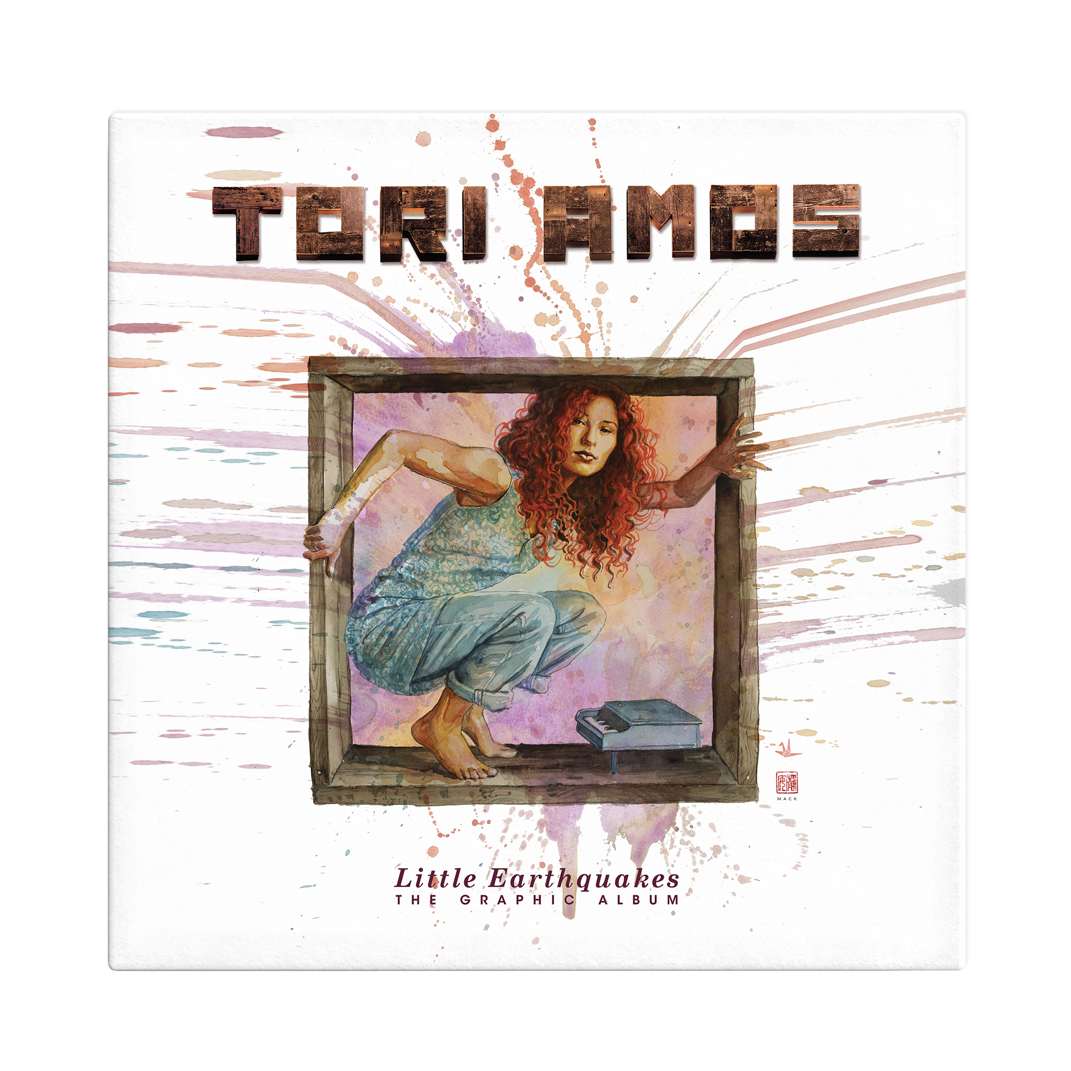 A slipcase showing a watercolor of Tori Amos by David Mack. She is crouched in a wood box over a tiny piano. Watercolor splatters outward from the box. Above her reads "Tori Amos" in wood letters below it says "Little Earthquakes The Graphic Album"