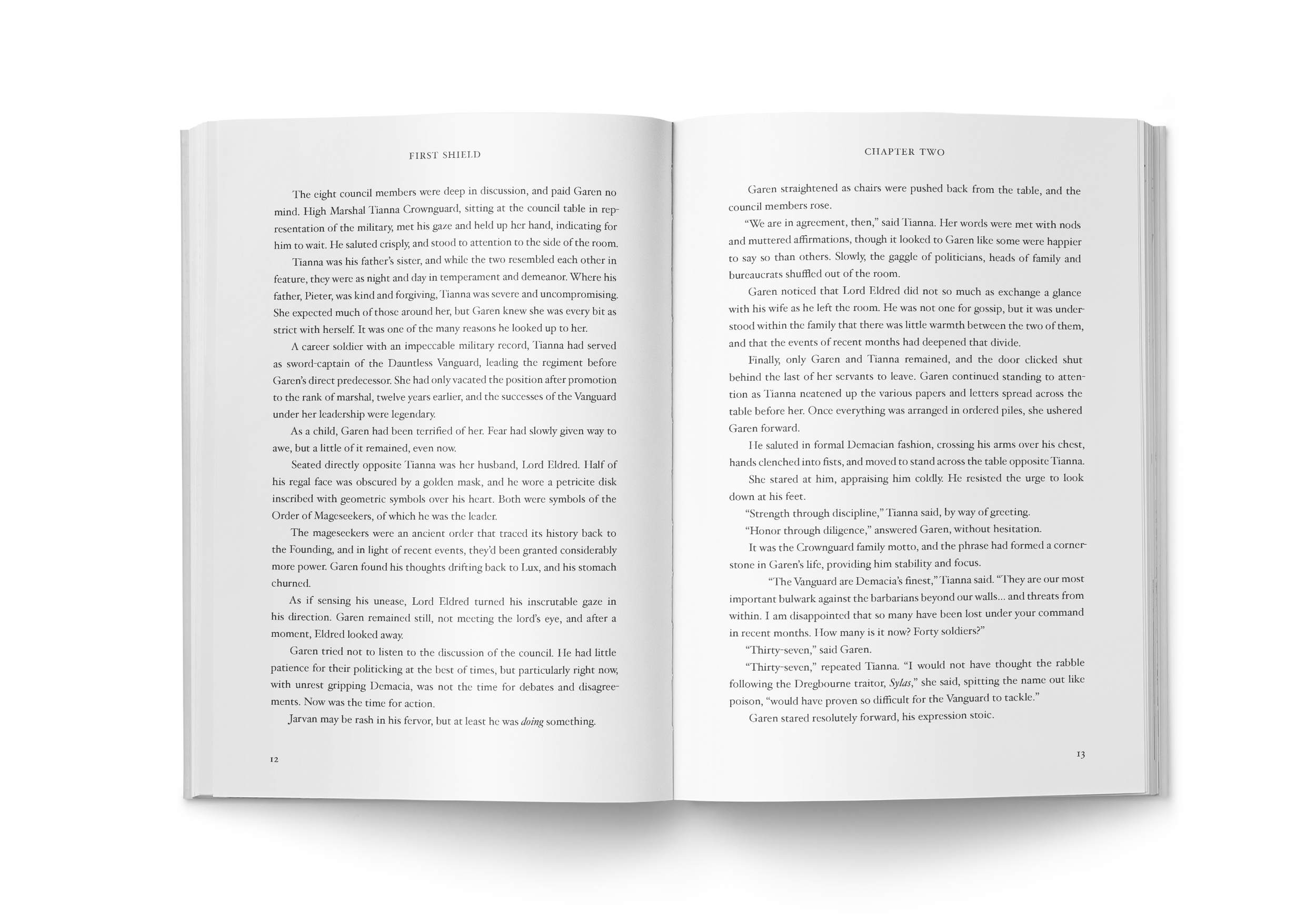 An open paperback book showing pages 12 and 13 of Garen First Shield. The text is black on white paper. The left page says "First Shield" at the top and the right page says "Chapter Two" at the top.