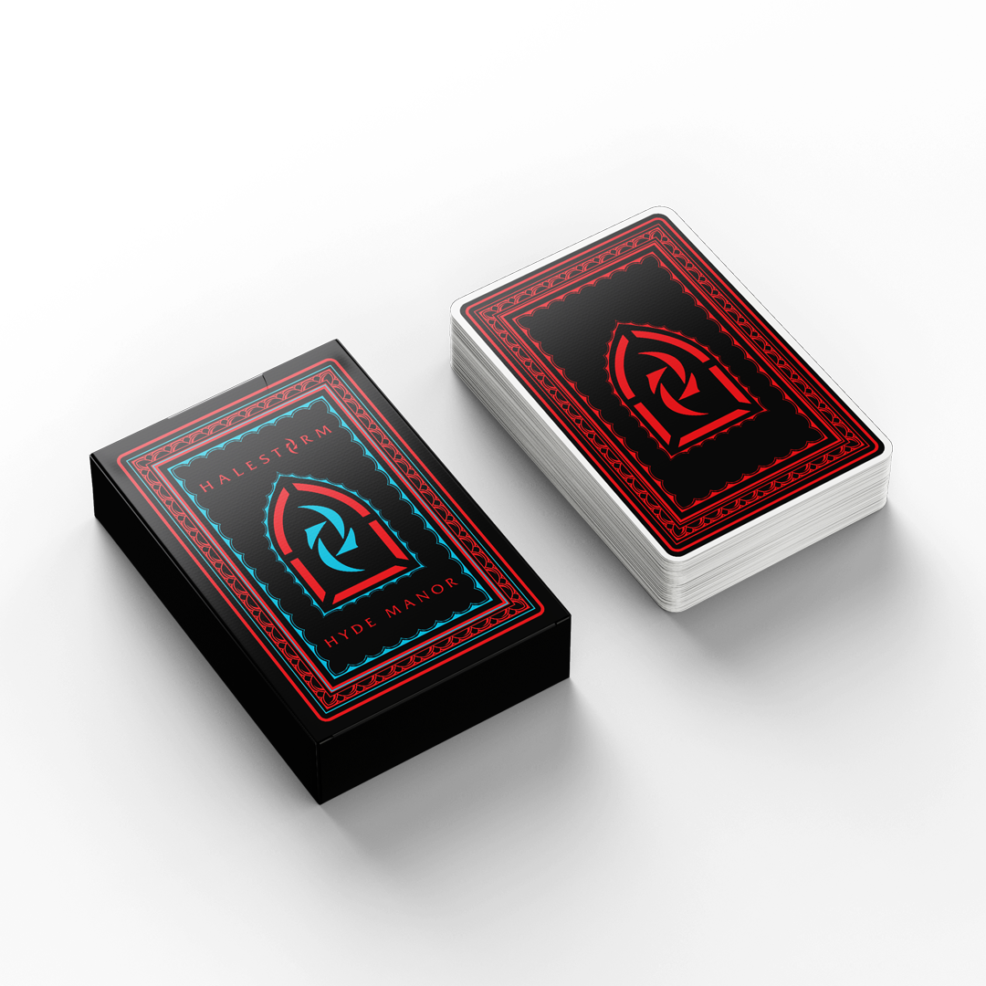 A playing card box with a stack of cards neck to it. The design is the design from the Hyde Manor slipcase.