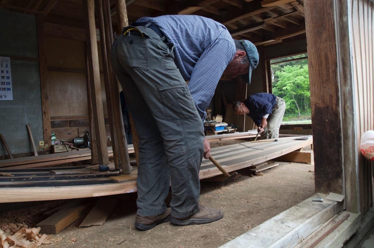 Pounding the edge of the bottom prior to fastening the side planks.