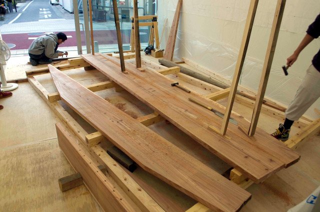 The three bottom planks propped in place for fitting seams.