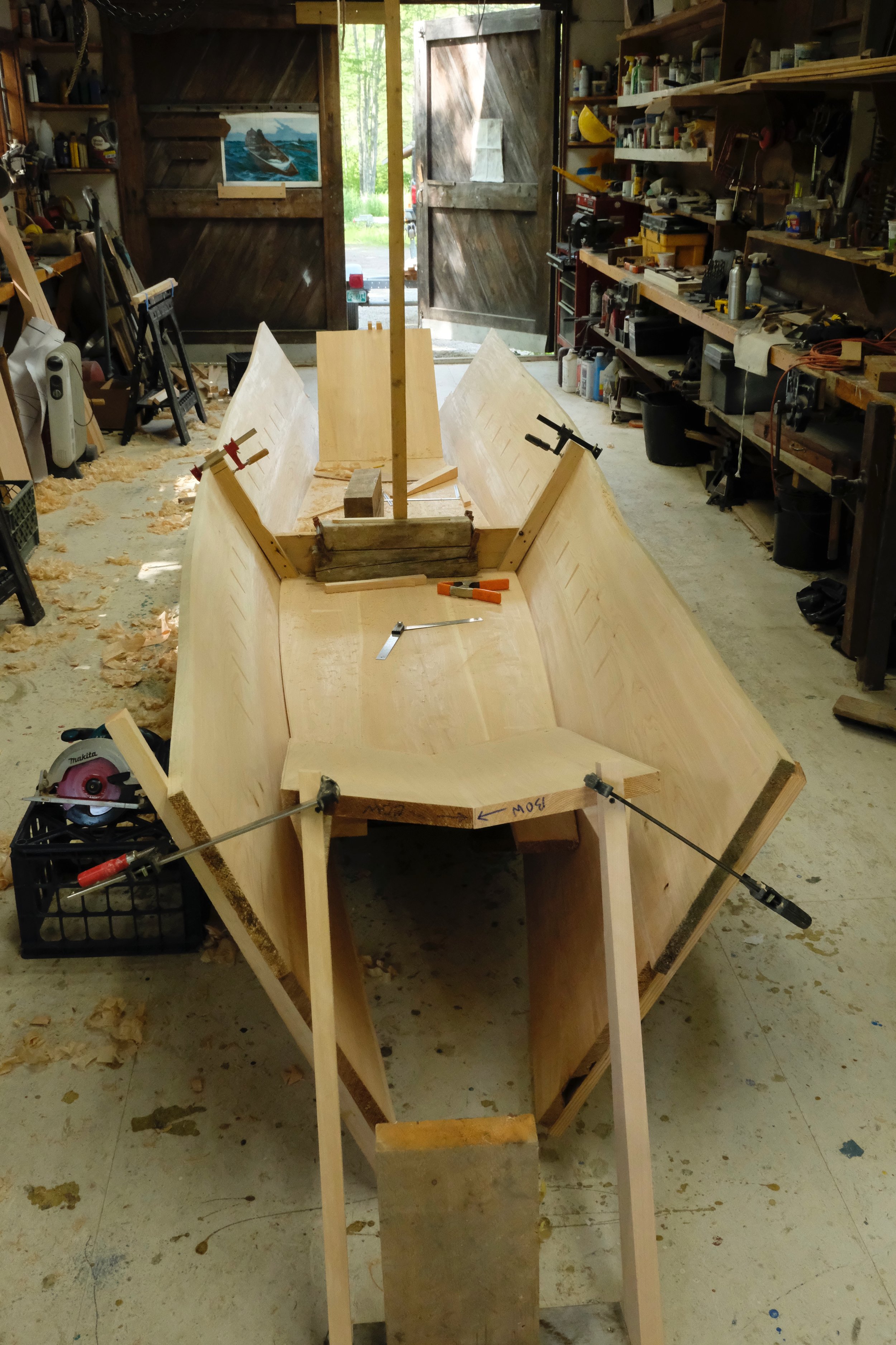 Bending the side planks to the backbone assembly.