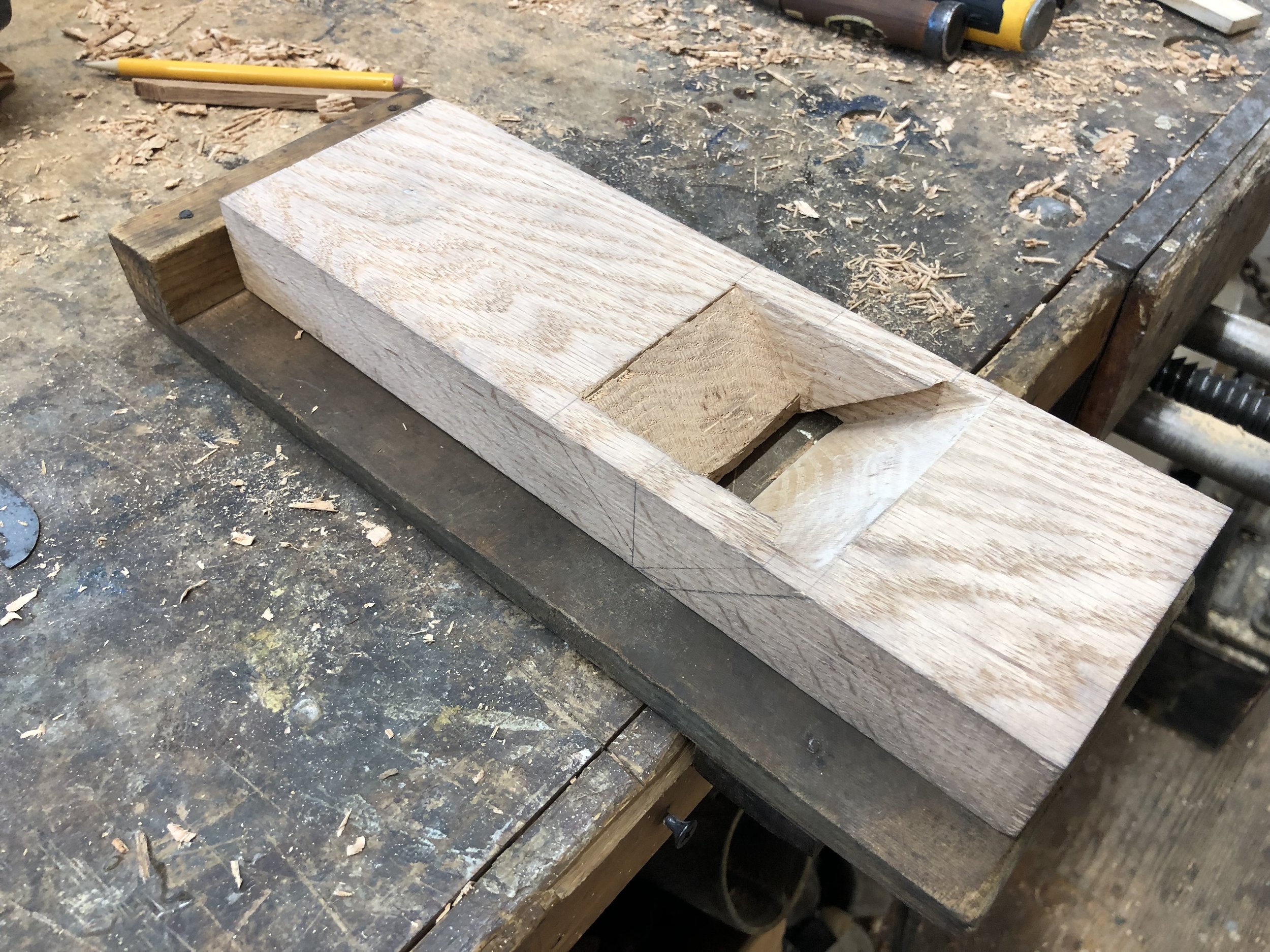 Students use chisels to cut the opening for their planes.