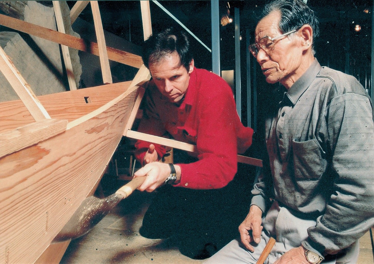 Douglas Brooks works saw-fitting a plank under the strict gaze of his teacher, Mr. Nobuji Udagawa.