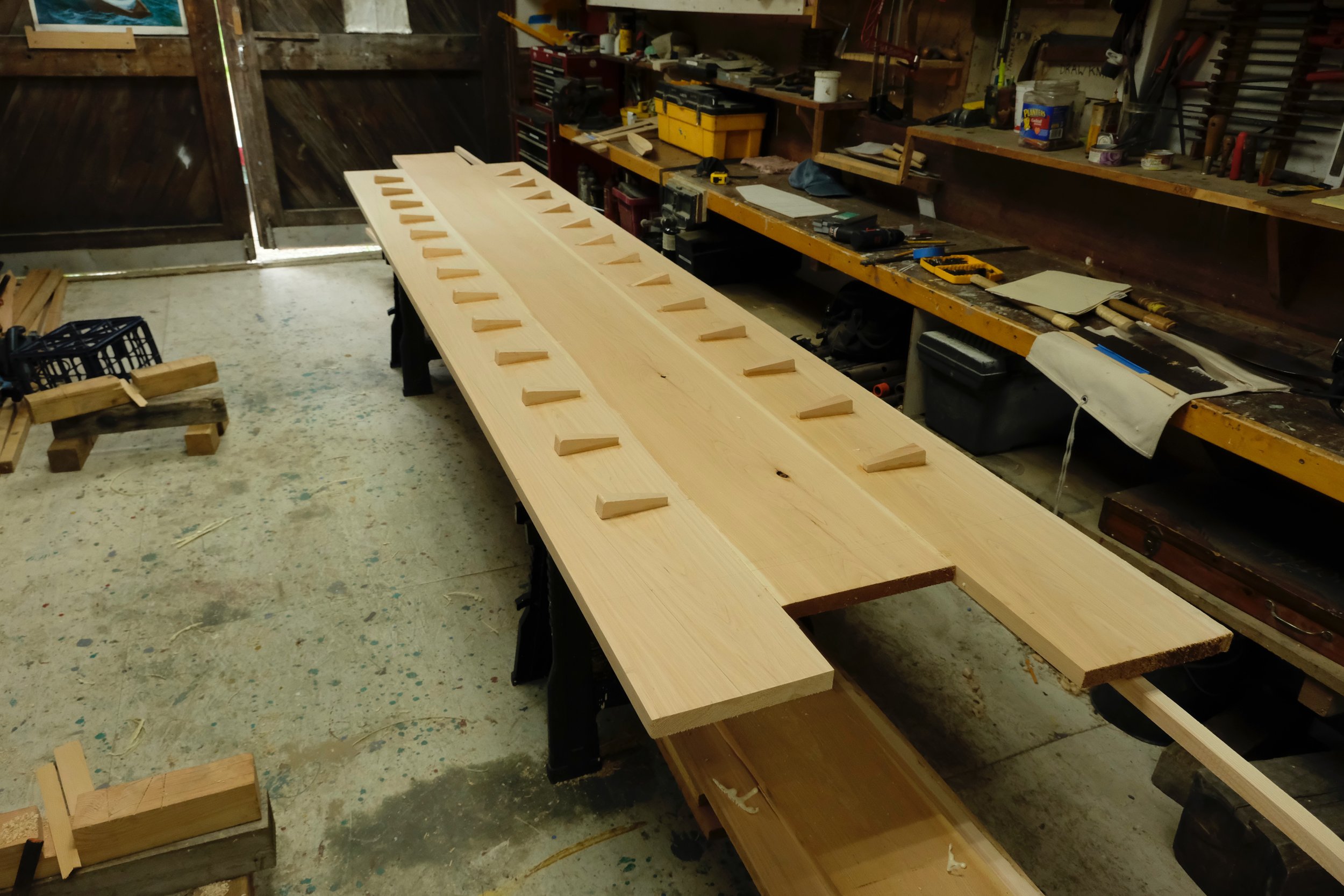 The bottom planks edge-nailed before the plugs were trimmed flush.