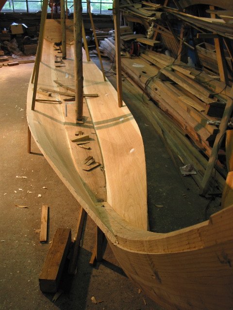 The first two planks fastened to the backbone.